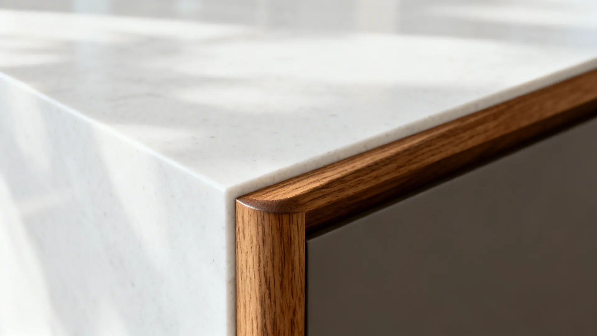 Macro of quartz counter with solid oak edge showing eased radius and sealed wood grain.
