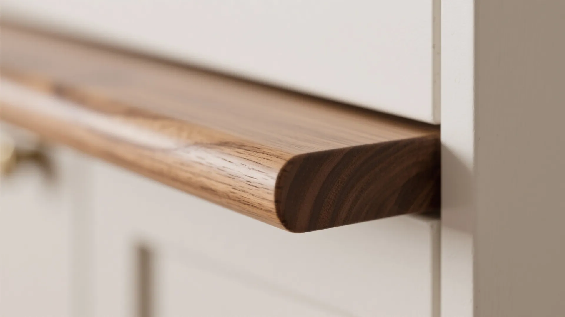 Close up view of a smooth brown wood shelf attached to a white wall cabinet