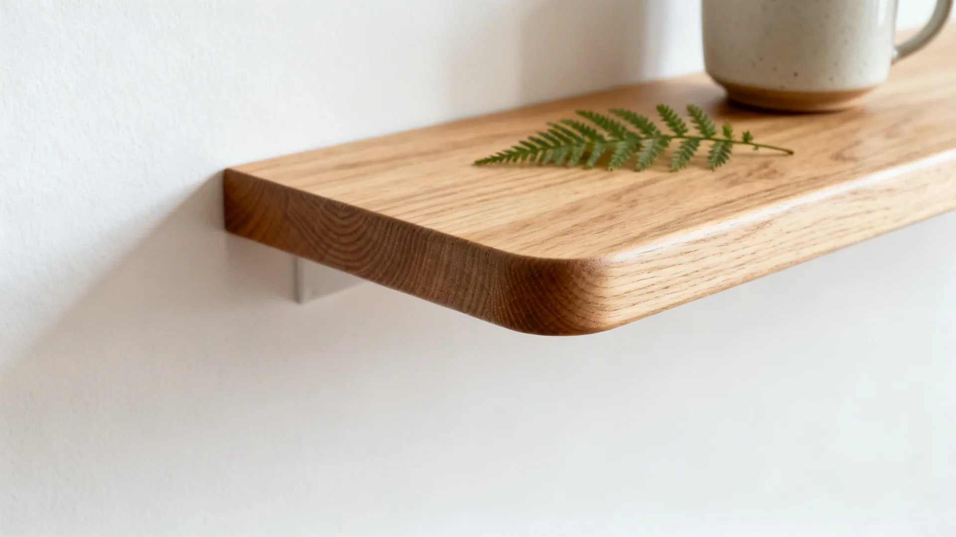 Macro of white oak shelf with hardwax finish and subtle grain in soft light.