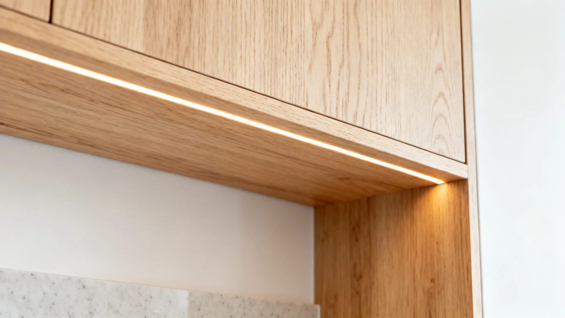Macro of a light-stain oak shelf with warm integrated LED and a smooth hardwax oil finish.