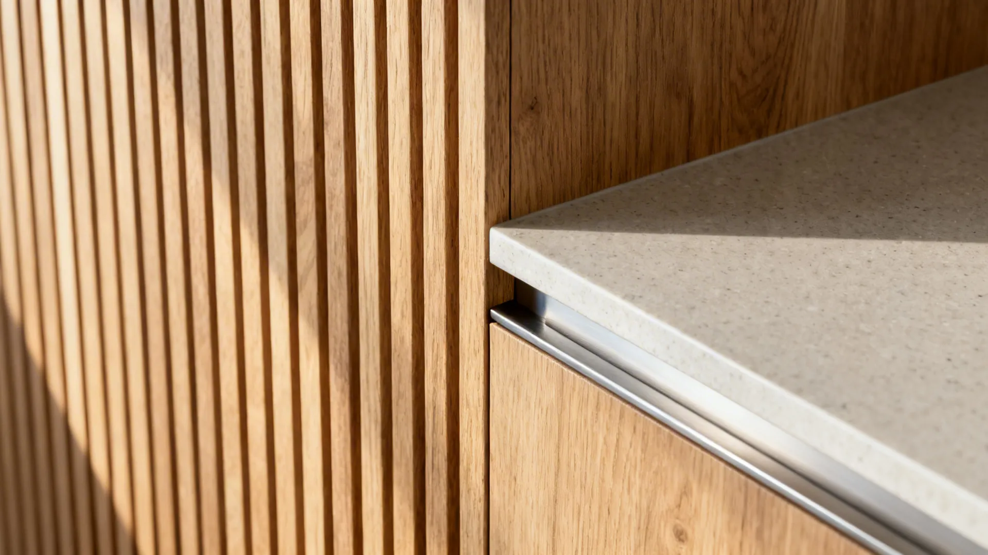 Macro of rift-cut oak slats and matte quartz edge with clean joinery and soft metal rail.