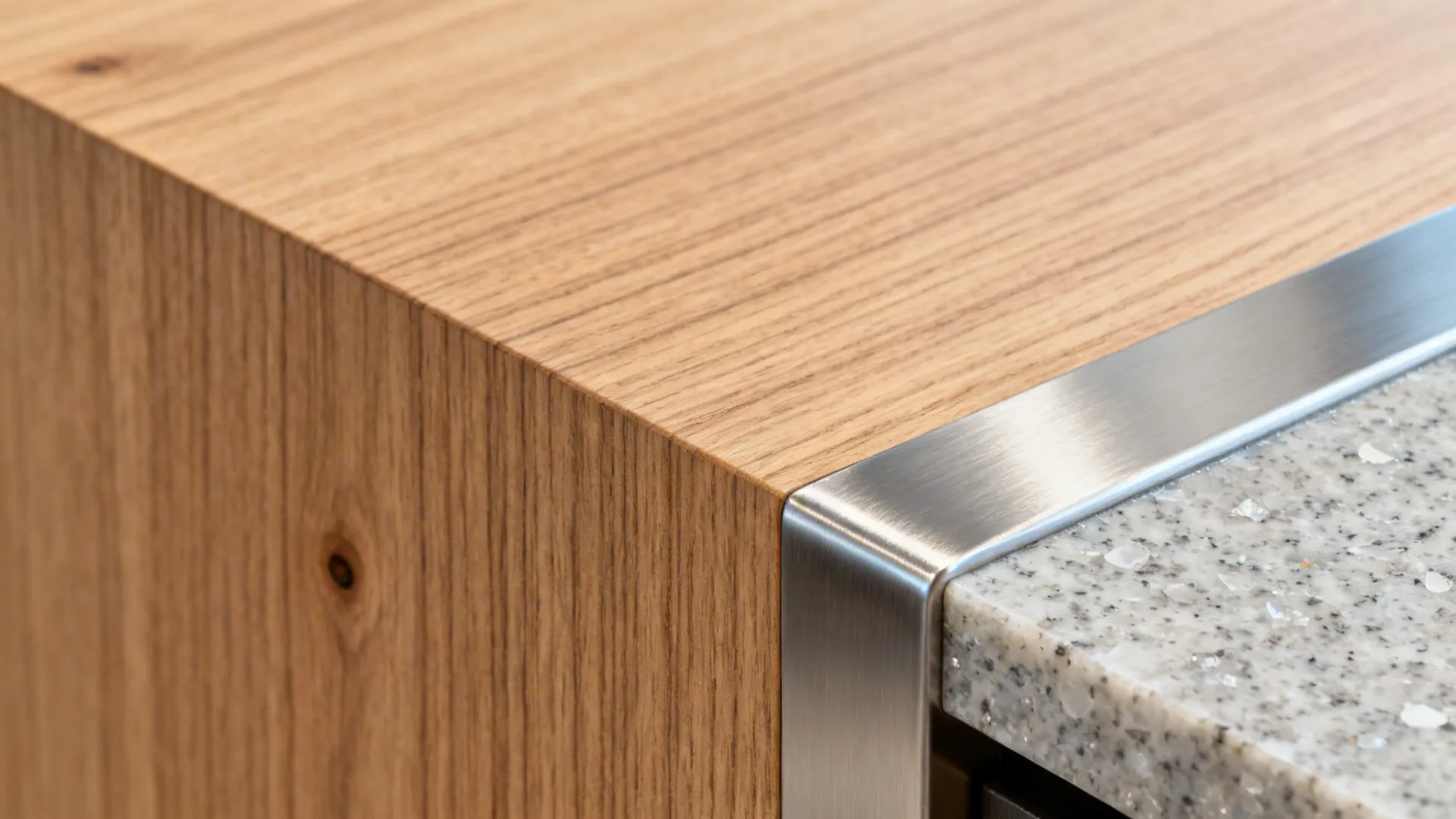 Close-up of rift-cut oak veneer beside brushed stainless and quartz, showing texture and finish.