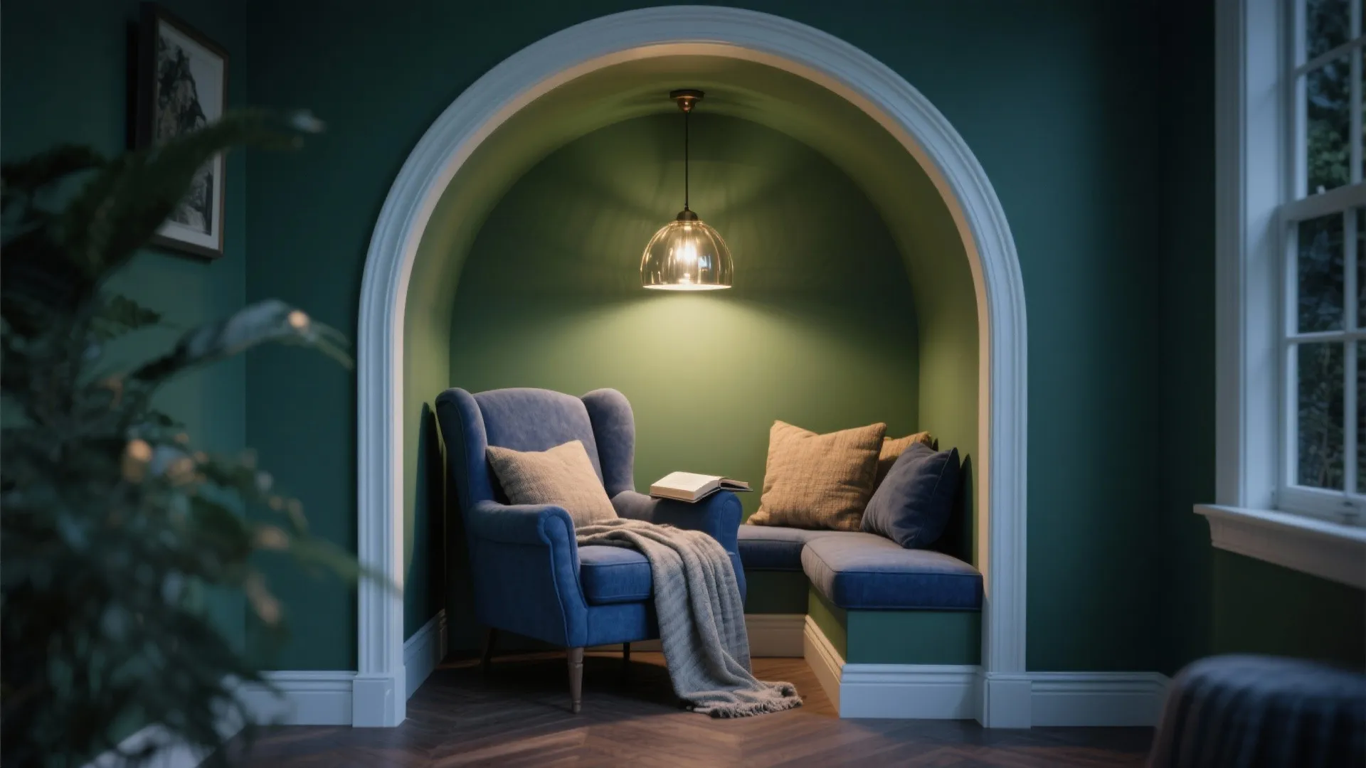 Cozy reading nook with olive green walls and stormy blue accents, linen textiles and pendant light