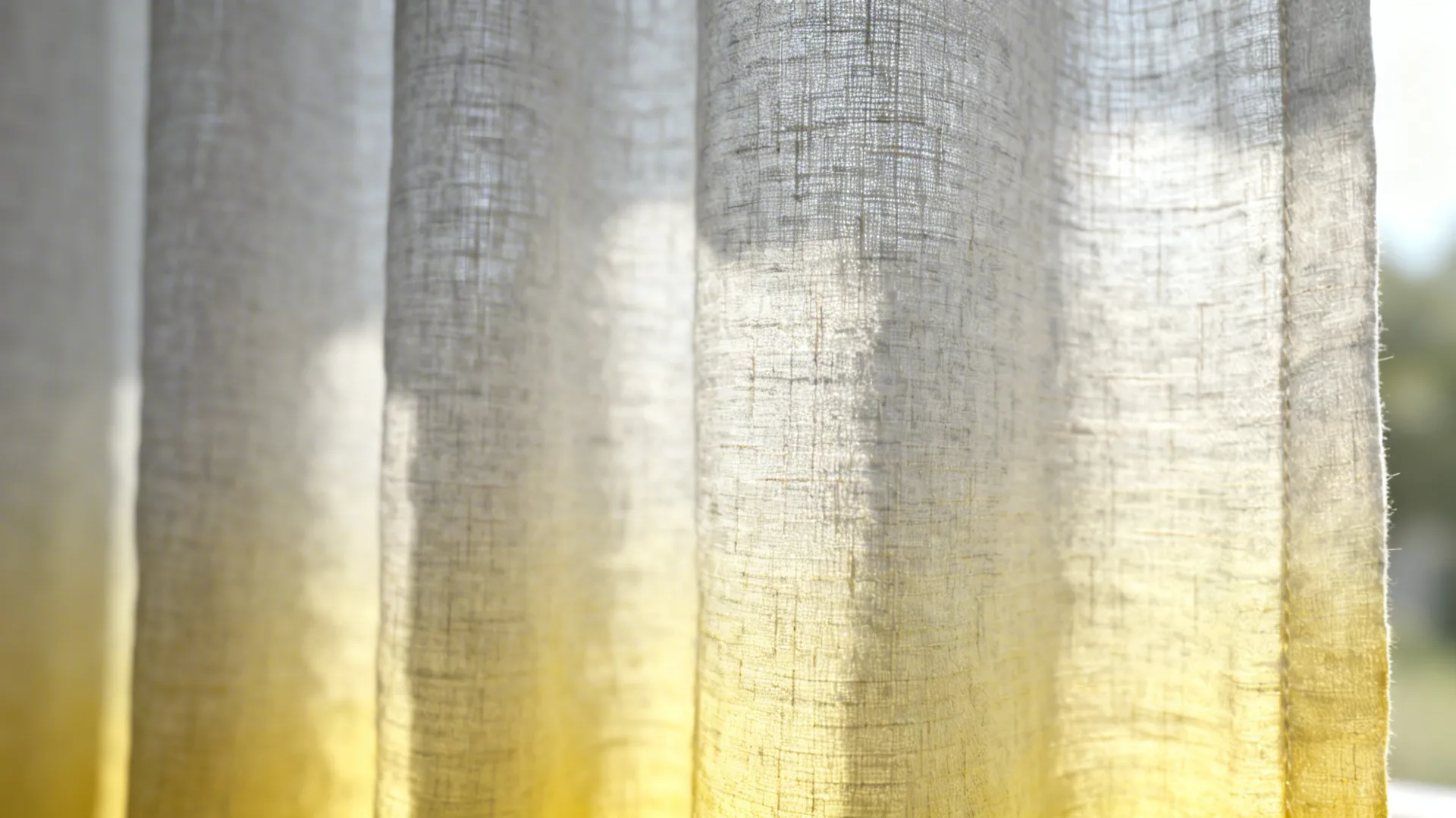 Macro of linen-blend ombre curtain from pale grey to butter yellow showing weave and soft drape.