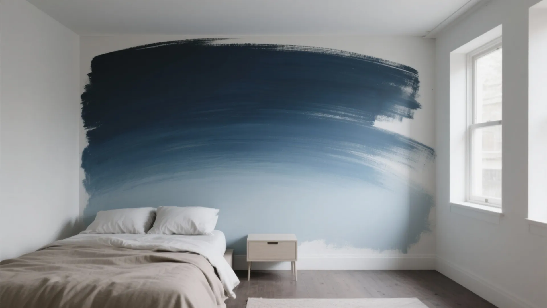 Minimalist bedroom featuring bed side table and blue ombre wash wall design with natural window light
