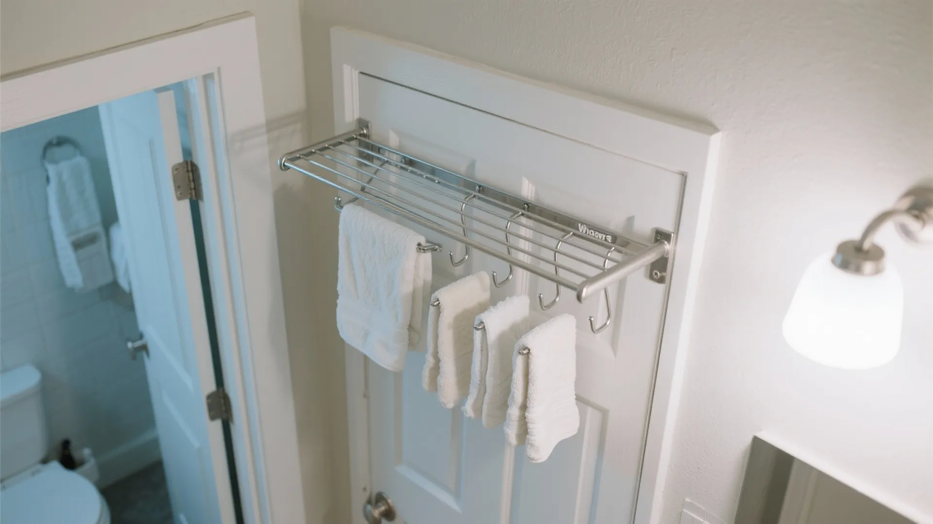 Over-the-door hanger rack with towels above bathroom door