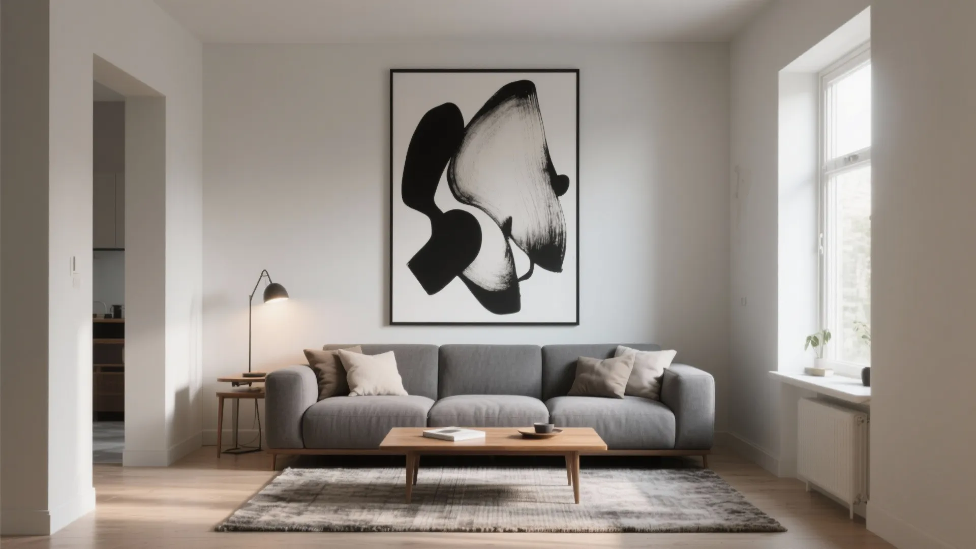 Minimalist living room with grey sofa wooden coffee table black white art and natural light