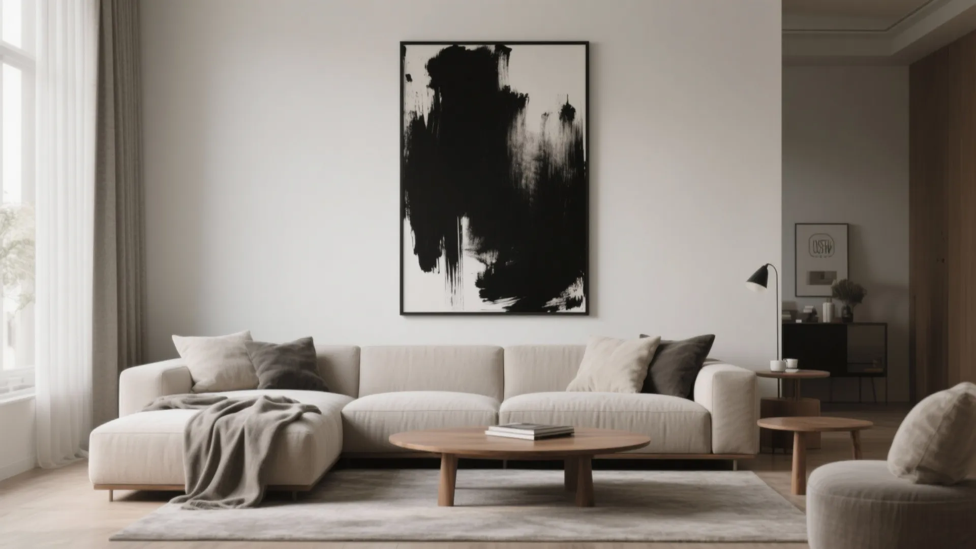 Oversized monochrome black canvas anchored above a sofa with warm wood accents and neutral textiles.