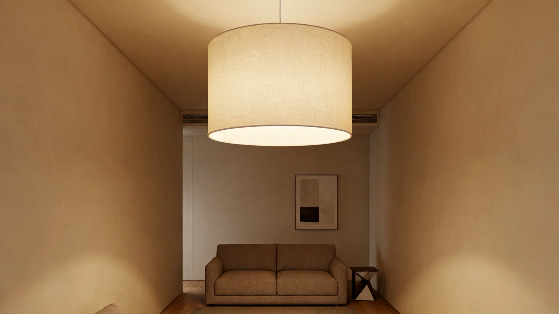 Narrow living room lit by an oversized drum pendant that diffuses warm ambient light across the space.