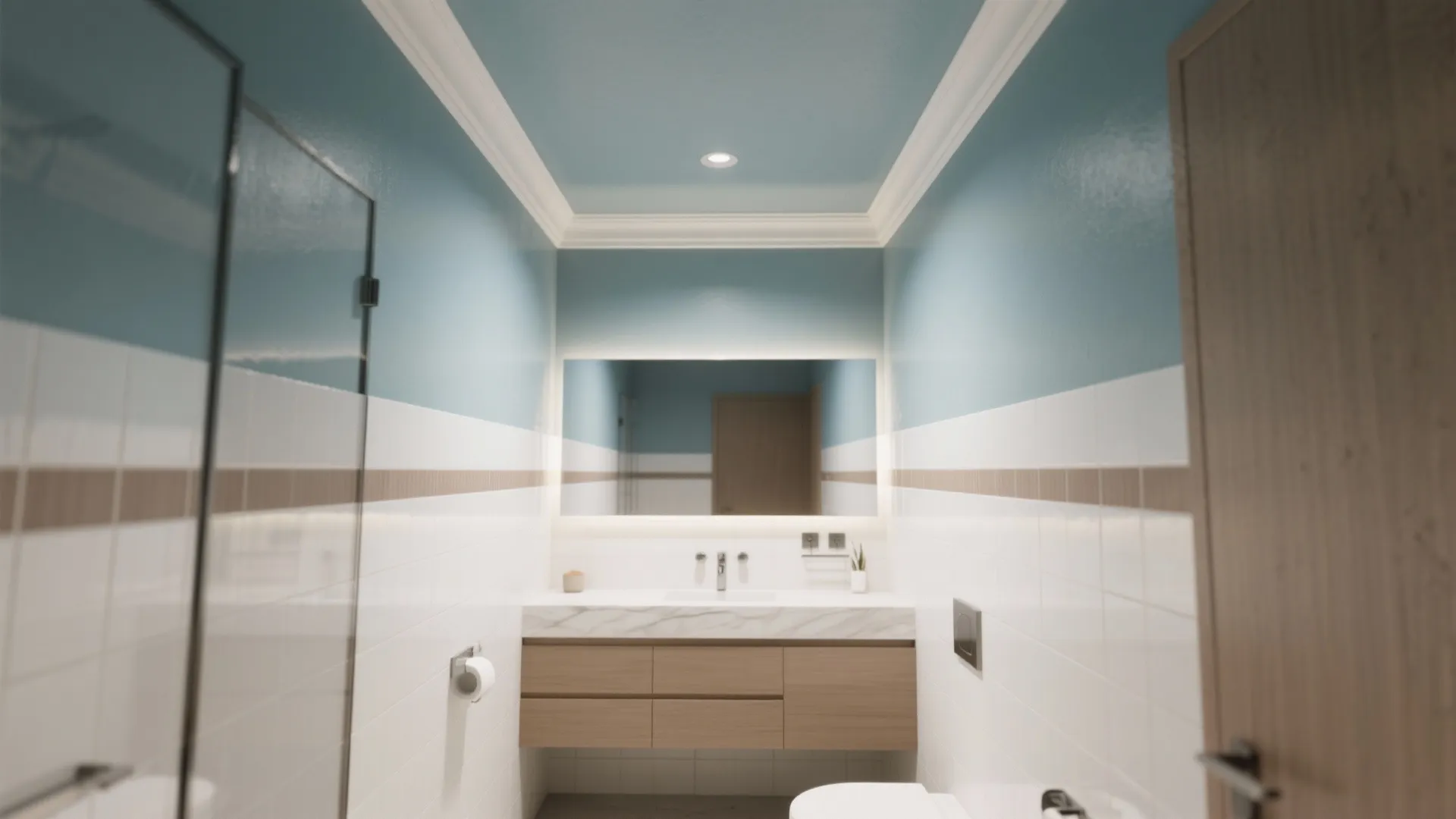 Small bathroom with blue upper walls white lower tiles wooden cabinet and large backlit mirror