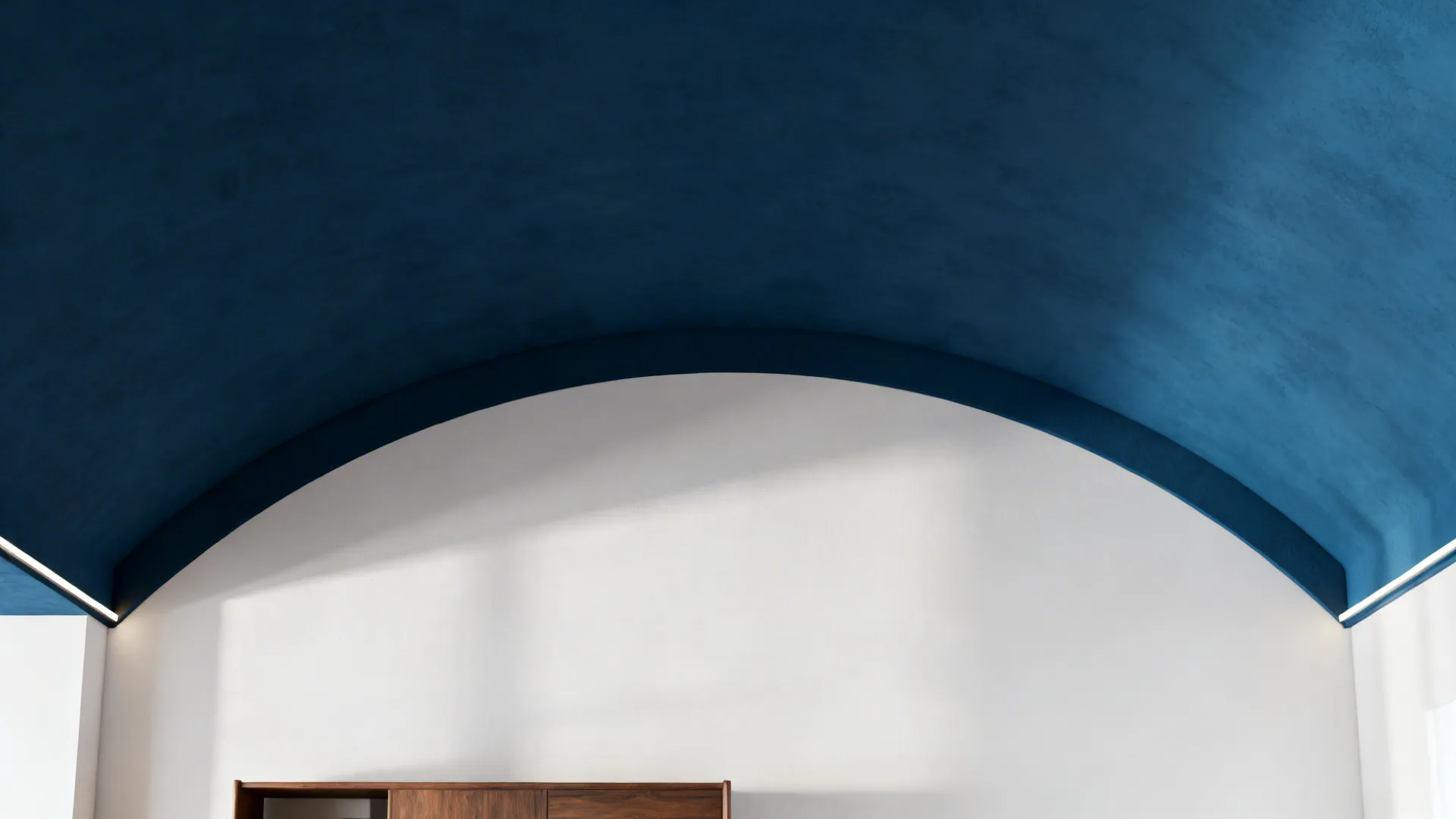Close view of a half-vaulted ceiling interior painted in a deep warm tone against white walls