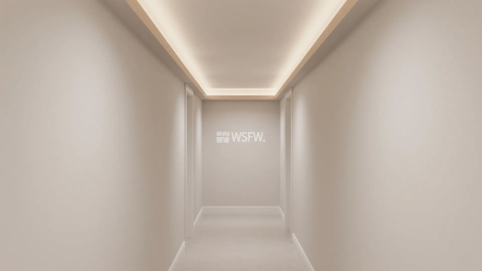 Hallway with beige walls and hidden ceiling lights creating a warm glow in a home