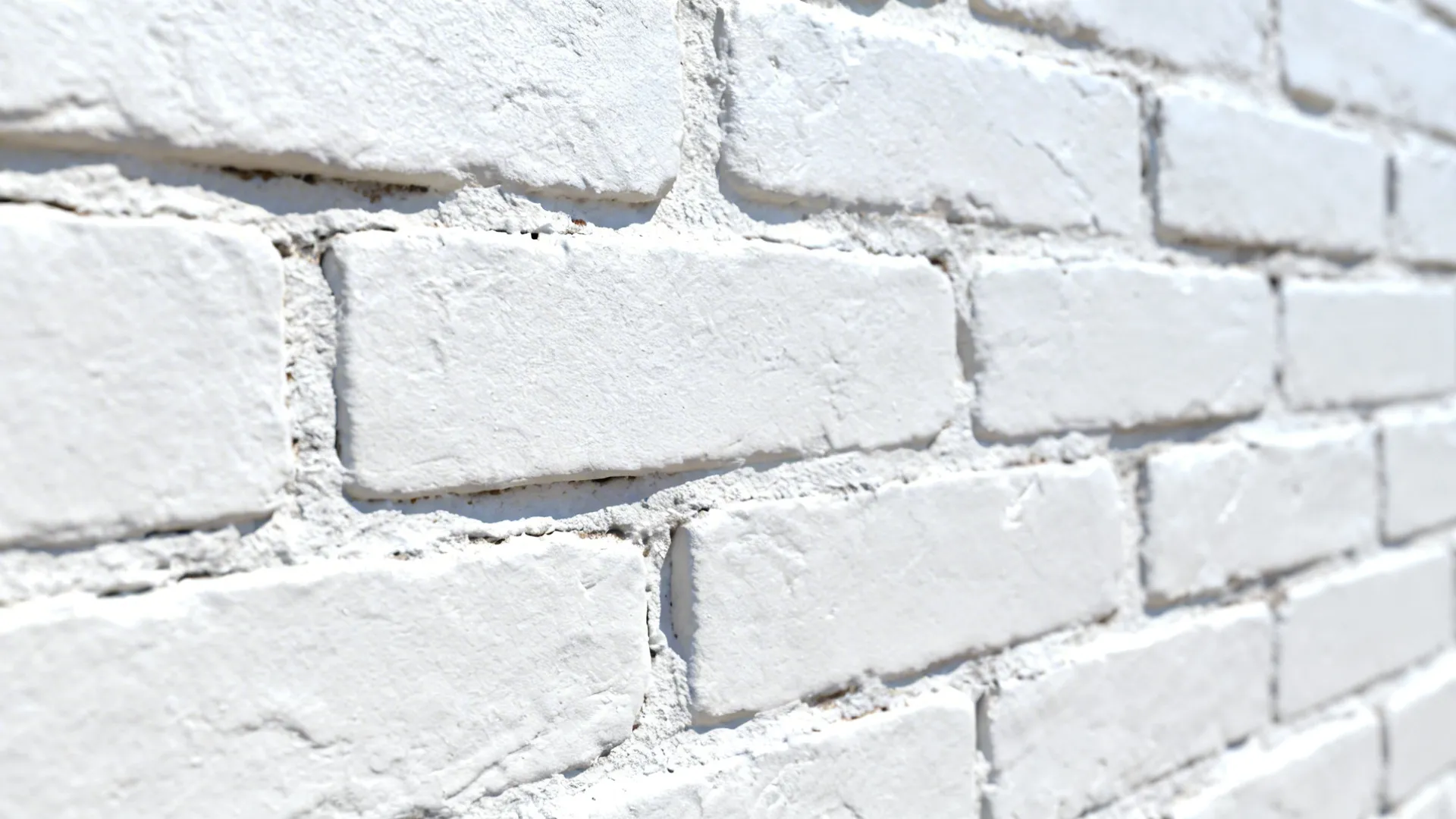 Close-up of painted white brick showing texture and mortar.
