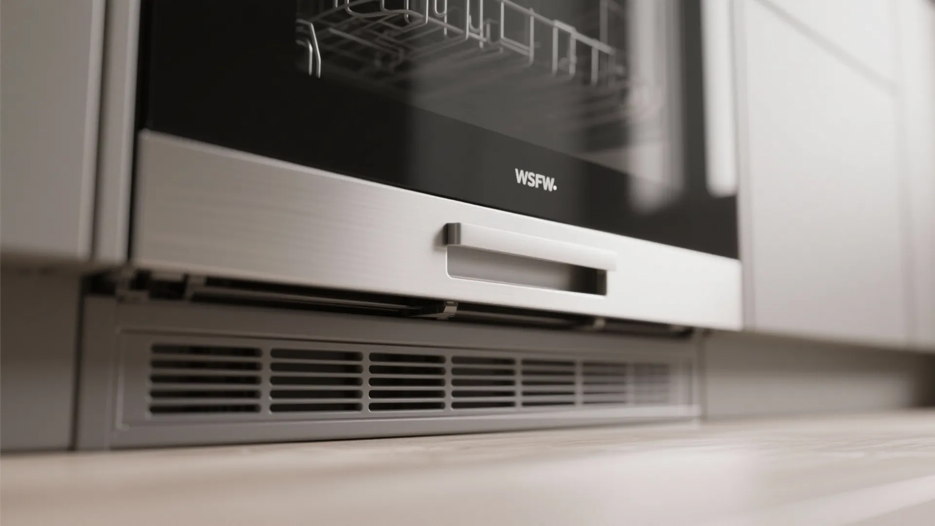 Macro of a panel-ready dishwasher front with soft-close drawer hardware and toe-kick ventilation gap.