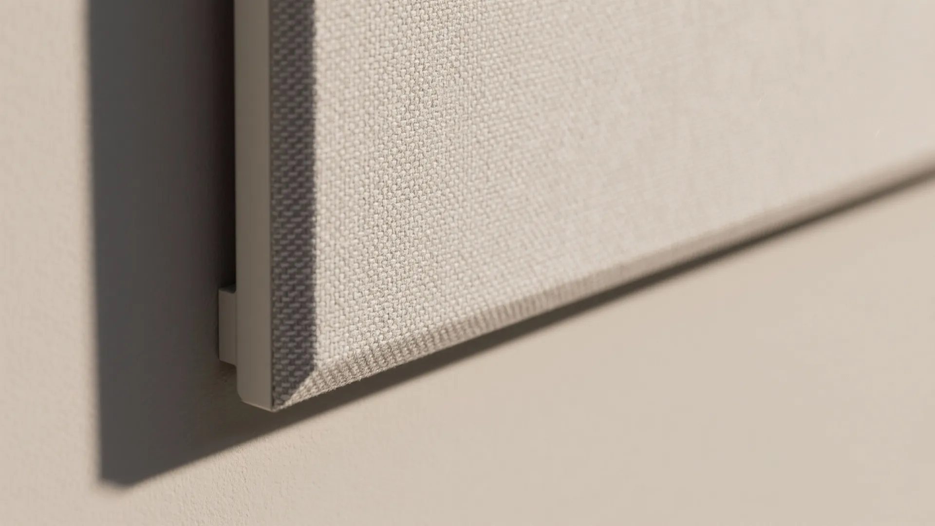 Close up view of light beige fabric material on a wall panel for interior room decoration