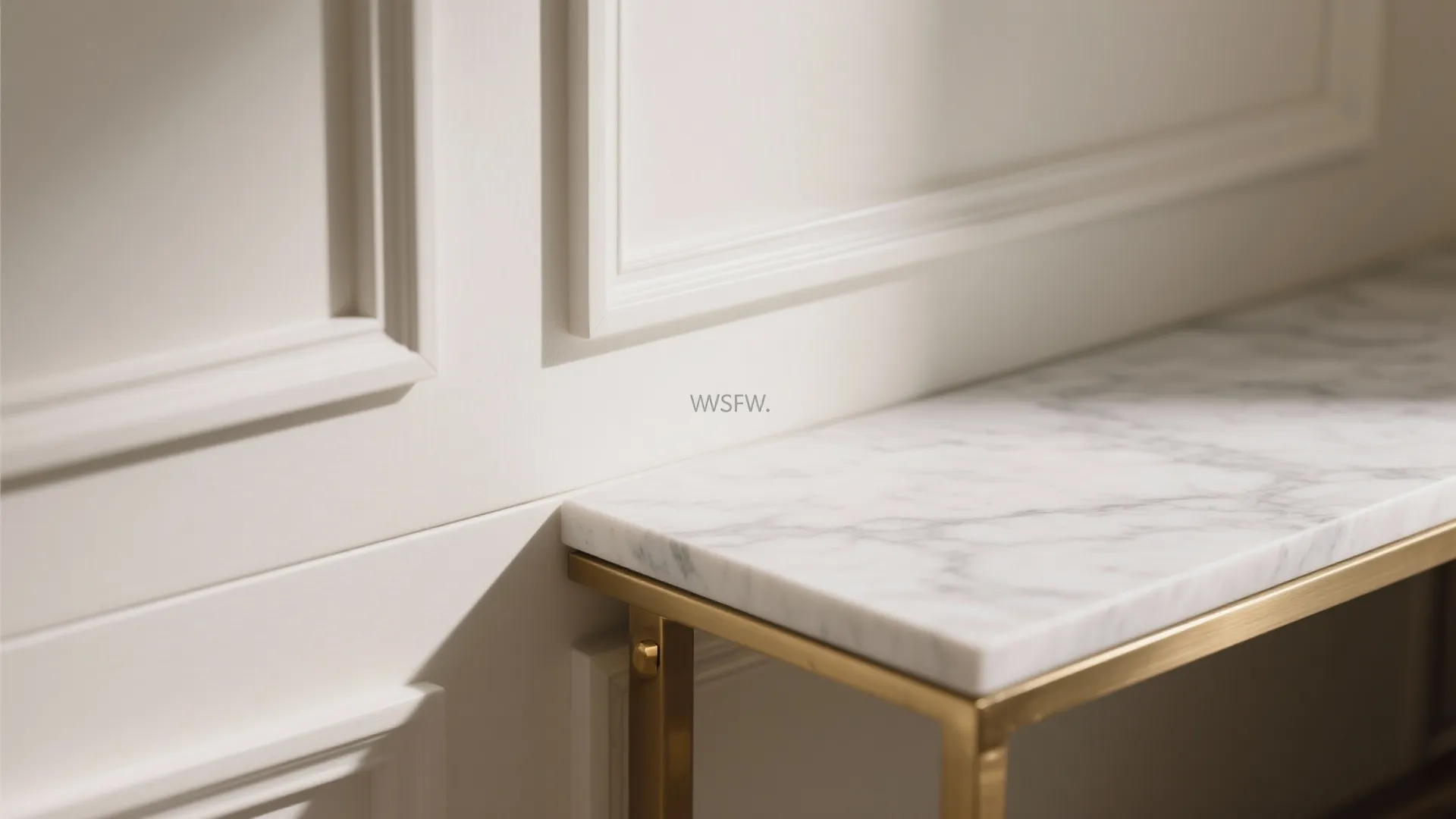 Macro detail of MDF panel reveal and quartz slab edge with satin brass hardware.