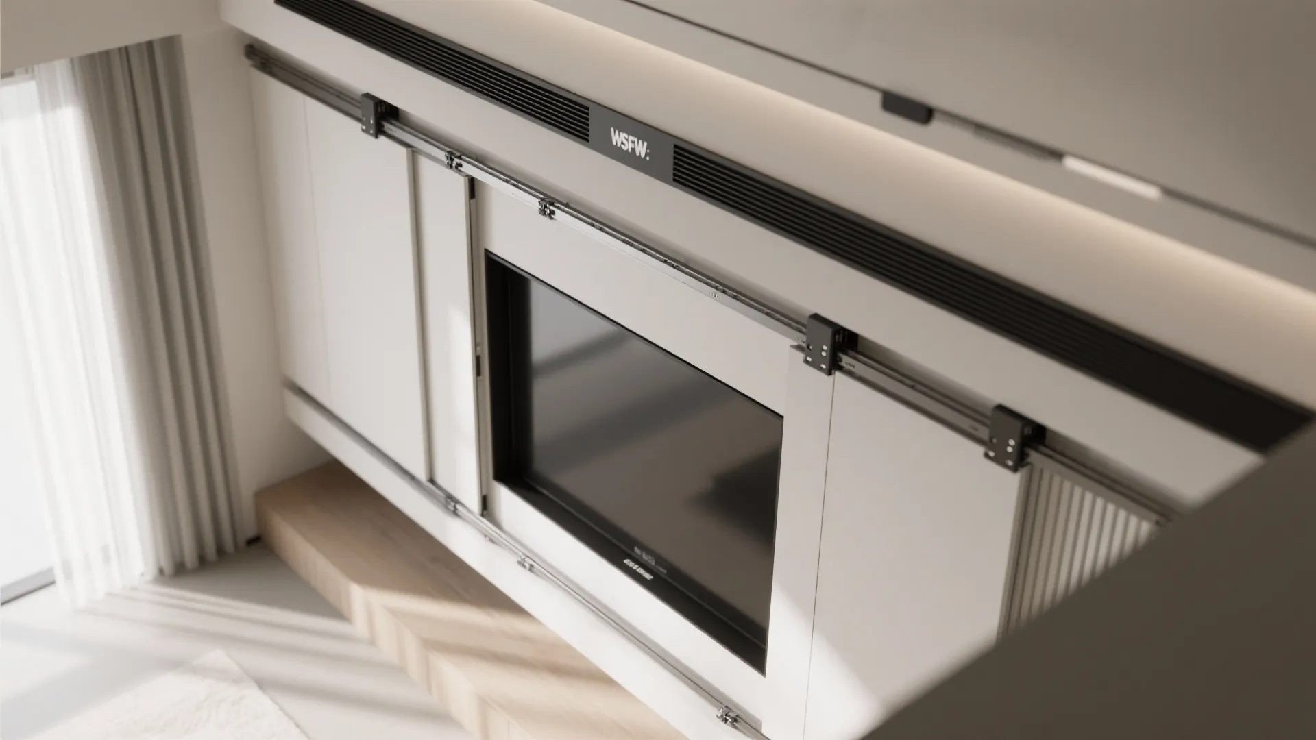 Close up view of sliding wall panel tracks installed above a television in a room