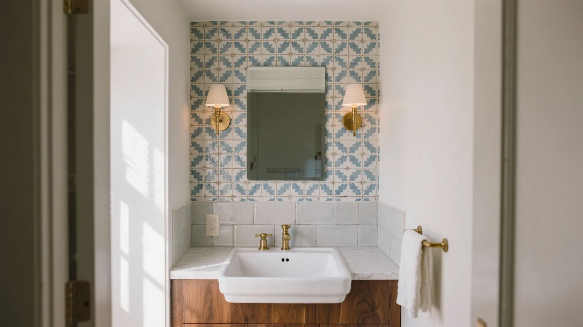 Patterned ceramic feature wall in a tiny powder room with matte tiles on the other walls.
