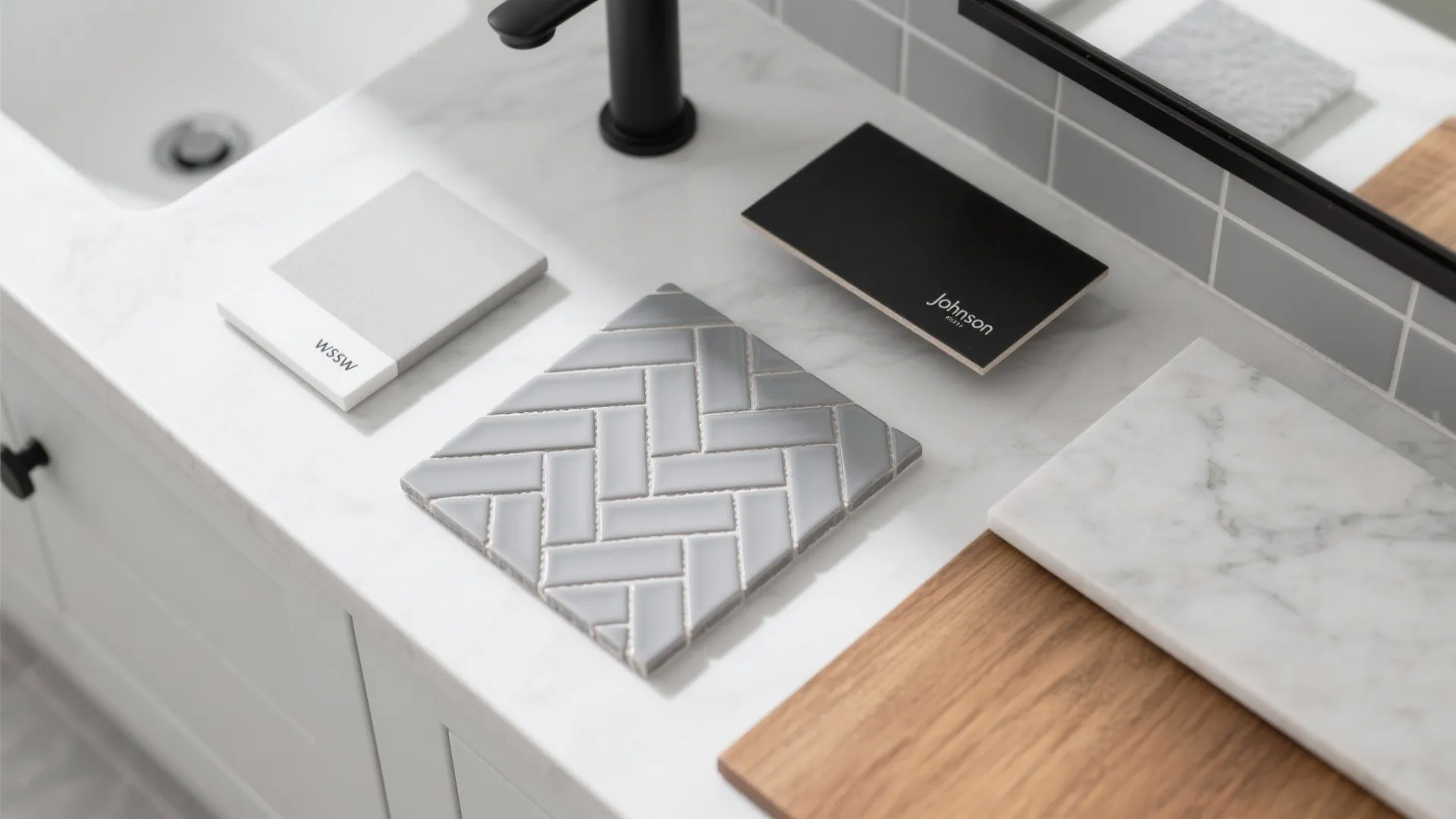 Material samples with grey pattern tiles wood marble and black color boards on white stone counter