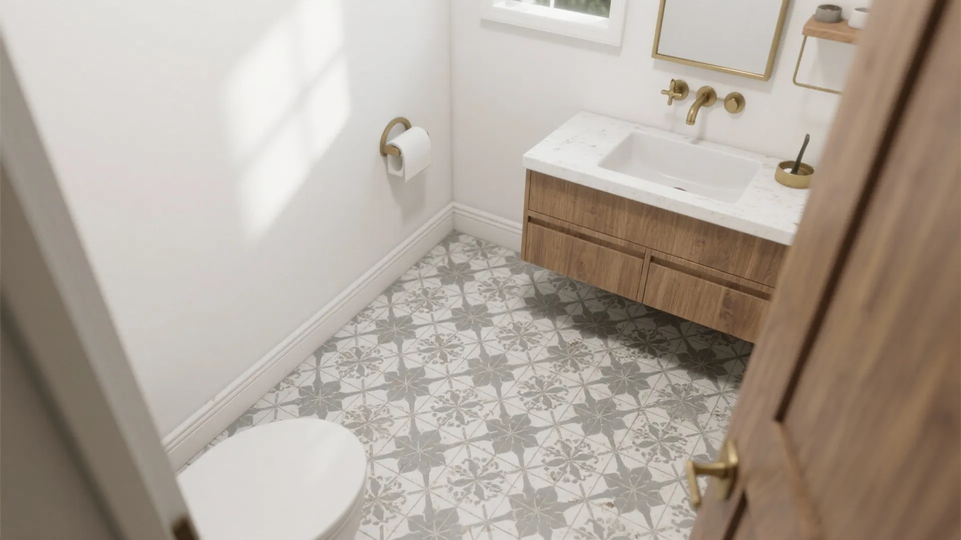 Modern bathroom featuring patterned floor tiles, wooden cabinet, white sink, golden taps, and toilet seat