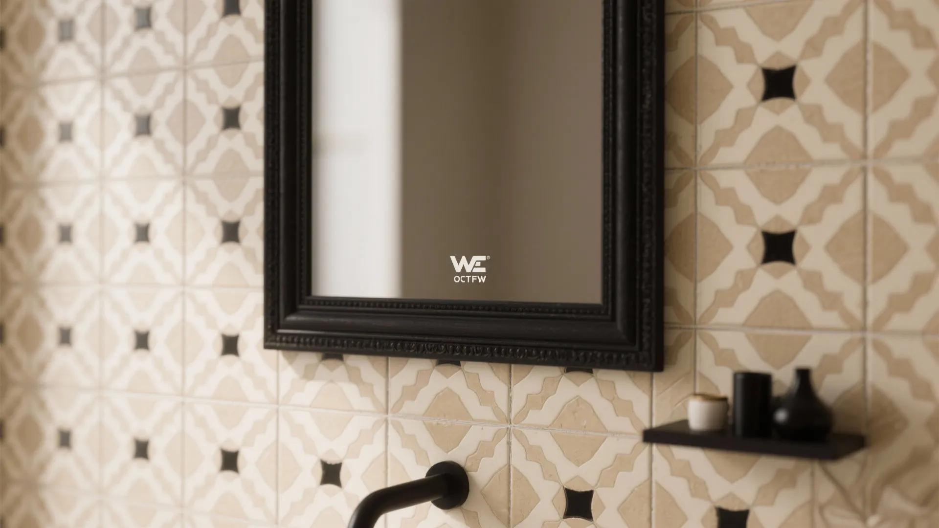 Black framed mirror hanging on a wall with beige and black patterned bathroom wall tiles