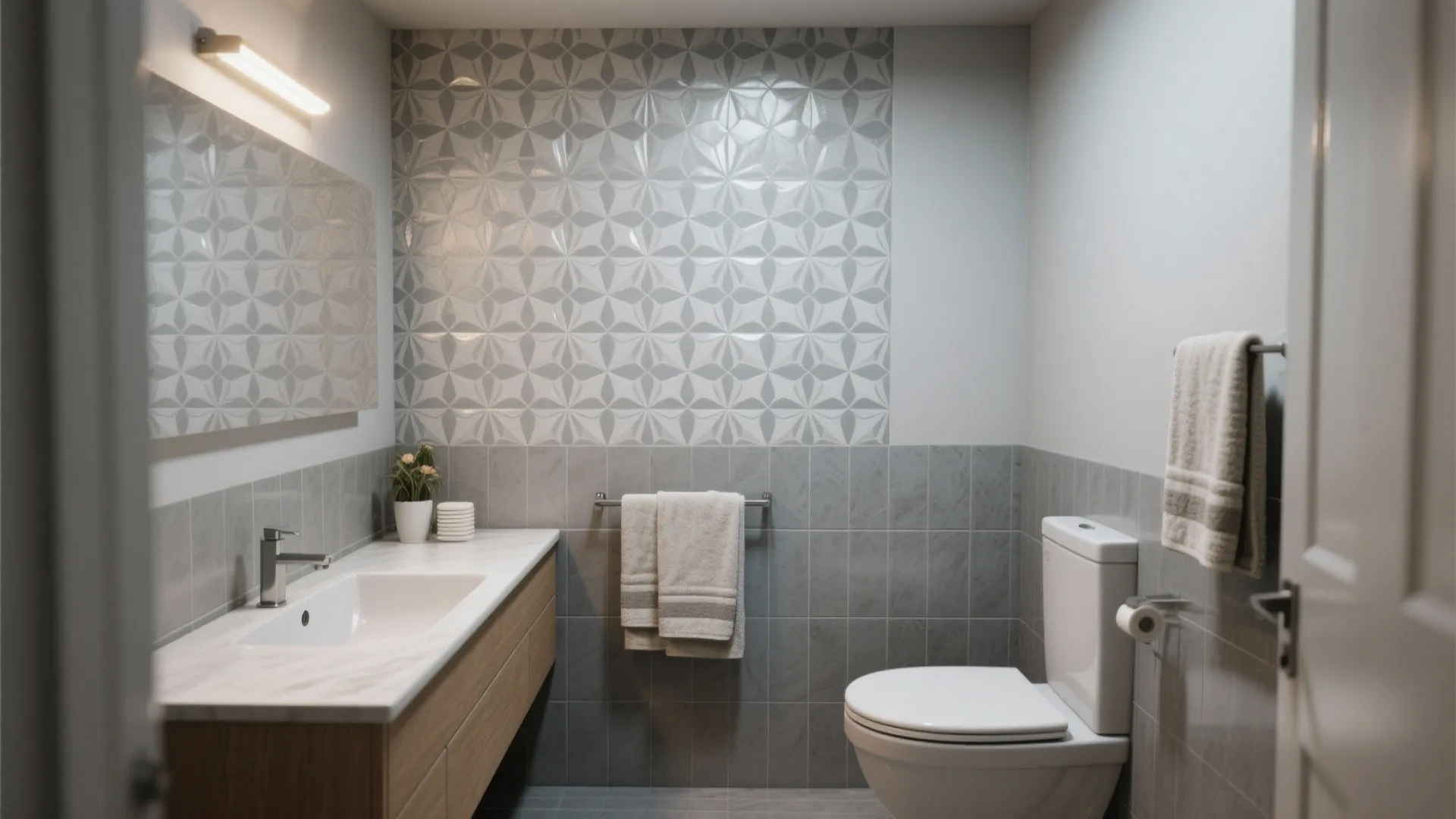 Compact bathroom with a single patterned grey tile feature wall behind the vanity.