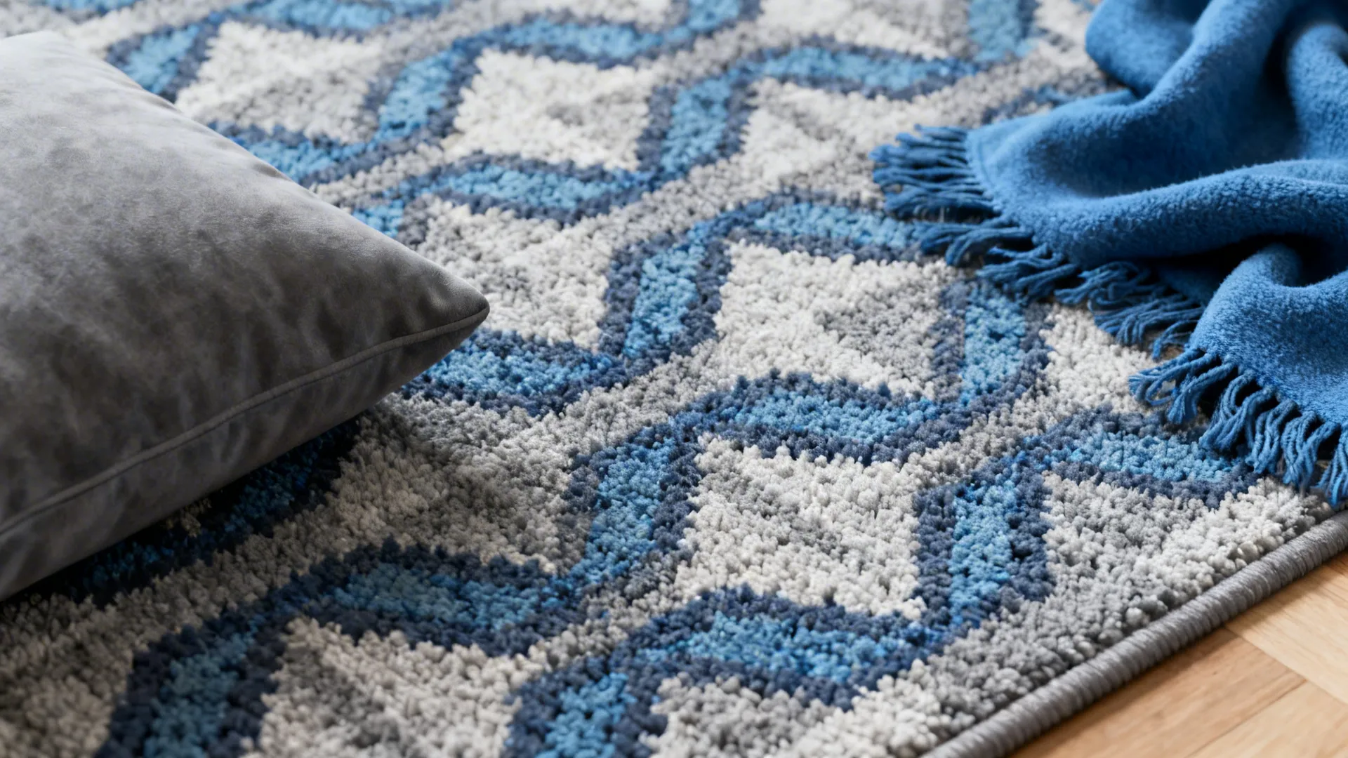 Close-up of a blue and grey patterned rug anchoring a small living room palette