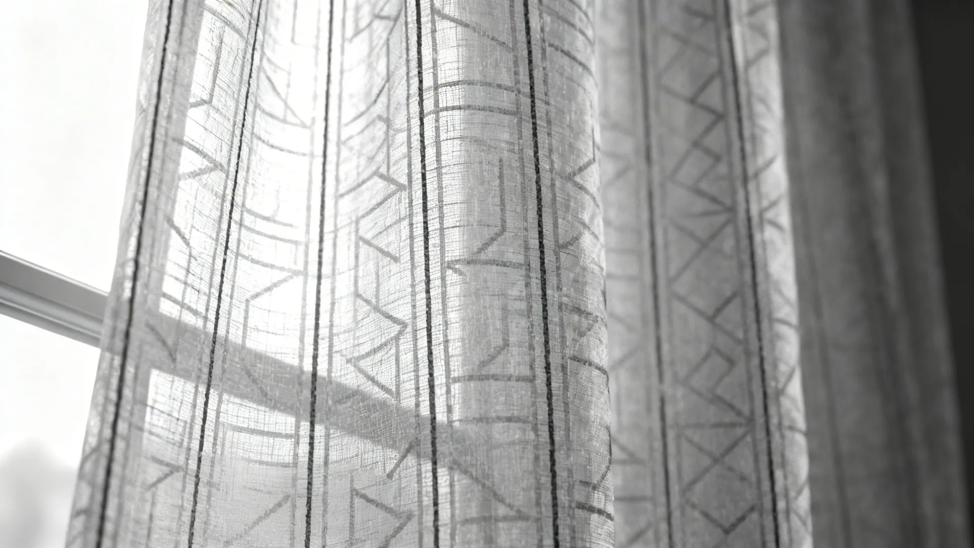 Close-up of patterned semi-sheer fabric showing subtle woven texture and translucence