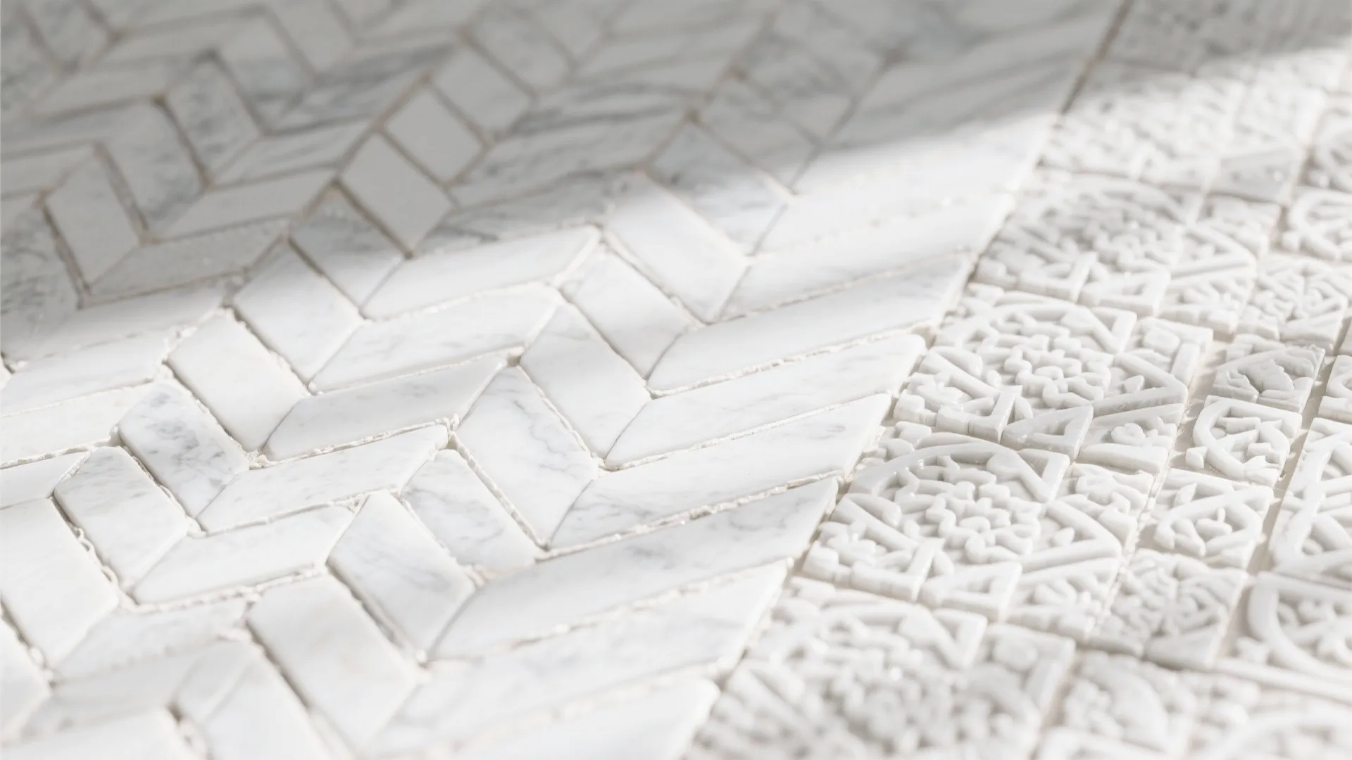 Close up of white marble floor tiles with a herringbone pattern and carved floral designs
