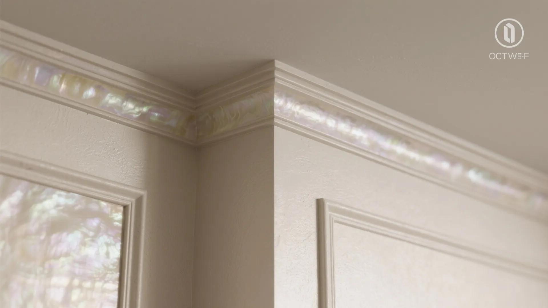 Close up view of white wall panel and decorative ceiling trim with iridescent shiny pearl finish