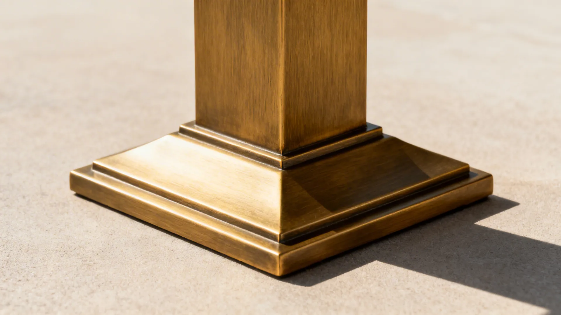 Macro of a solid pedestal table base with refined joinery and warm wood grain.
