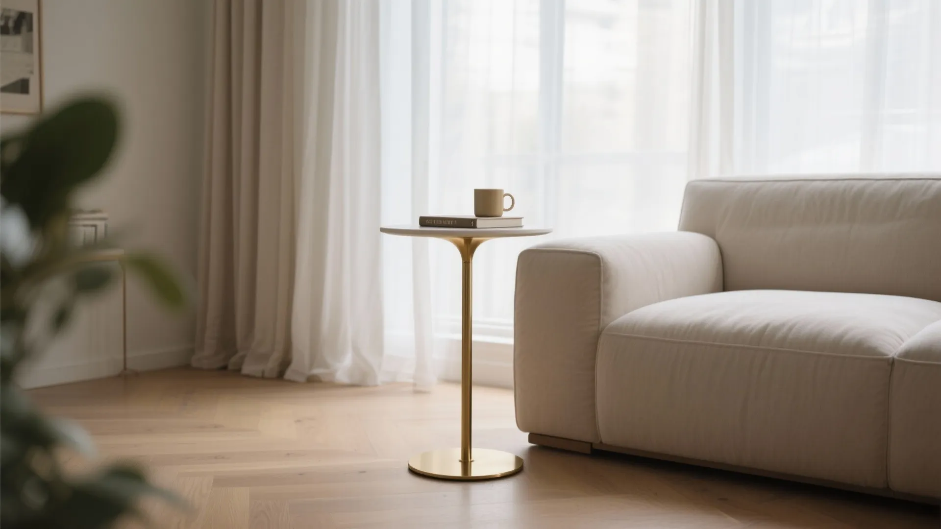 1) Slim pedestal table by the sofa arm