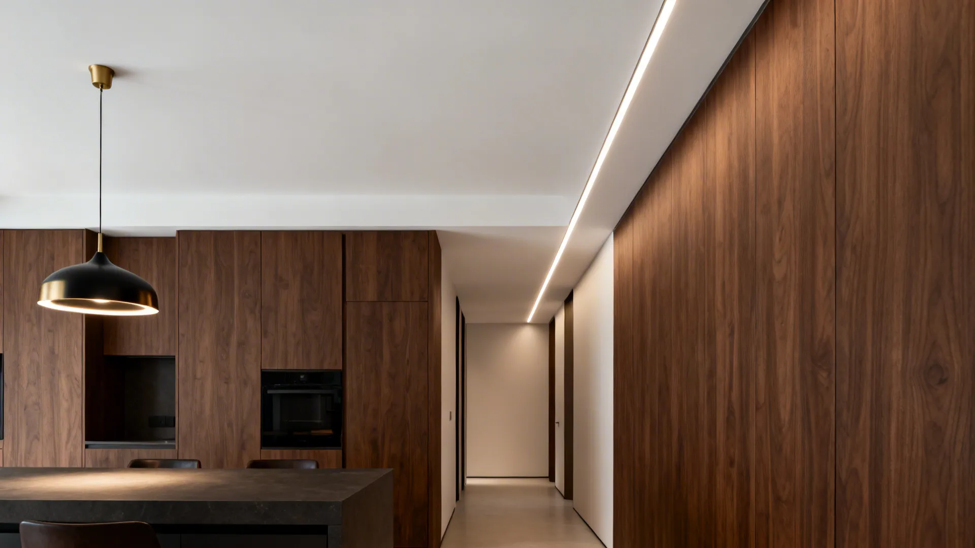 Low-ceiling kitchen with a correctly scaled pendant over the island and a slim linear profile in the hall.