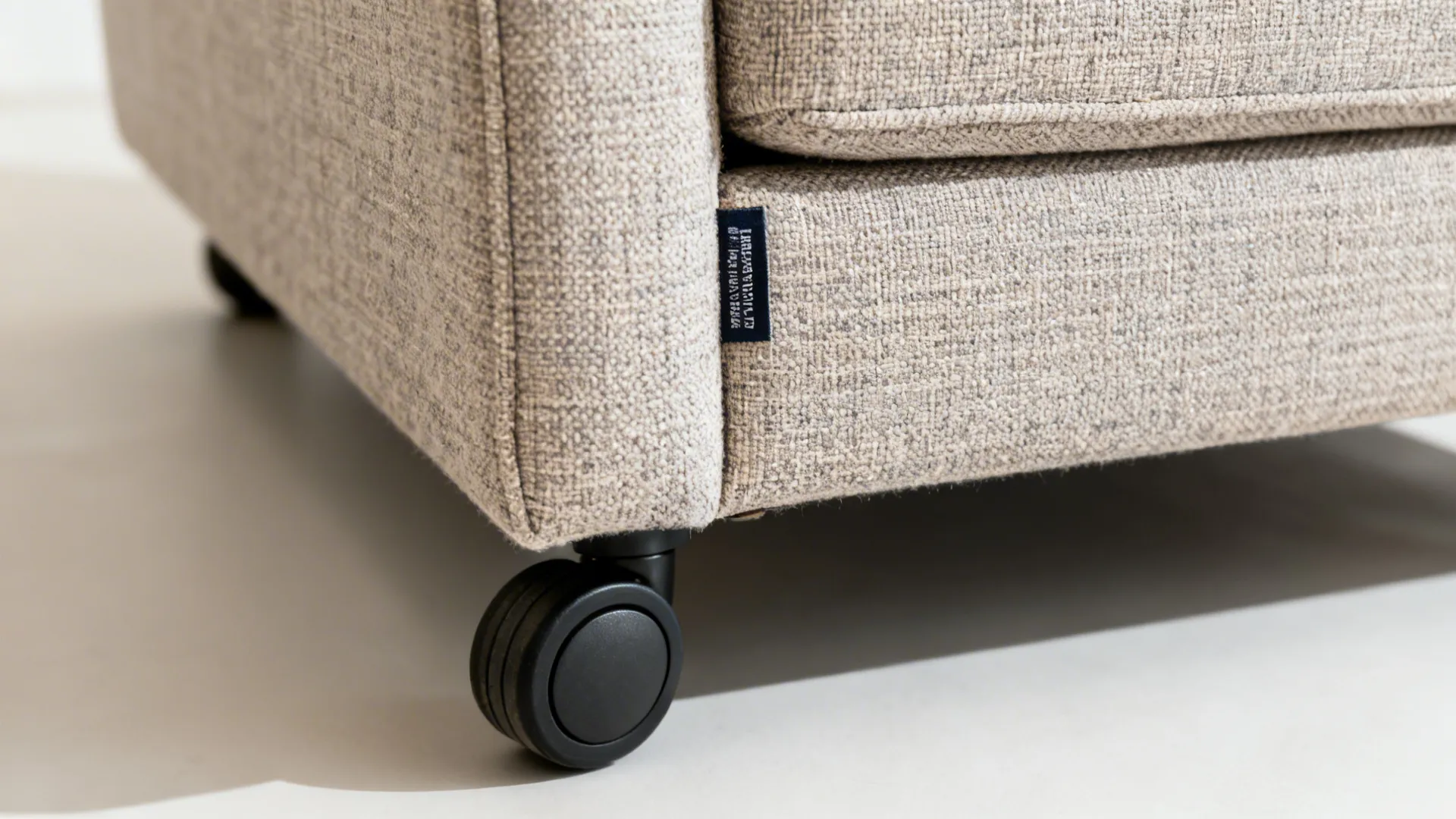 Close-up of performance fabric and soft-tread caster on a dining chair.