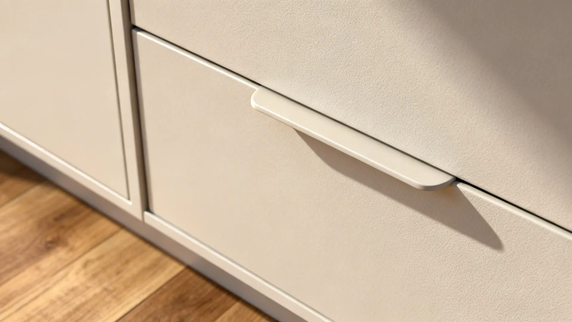 Macro of matte PET cabinet front and toe-kick drawer showing subtle texture.