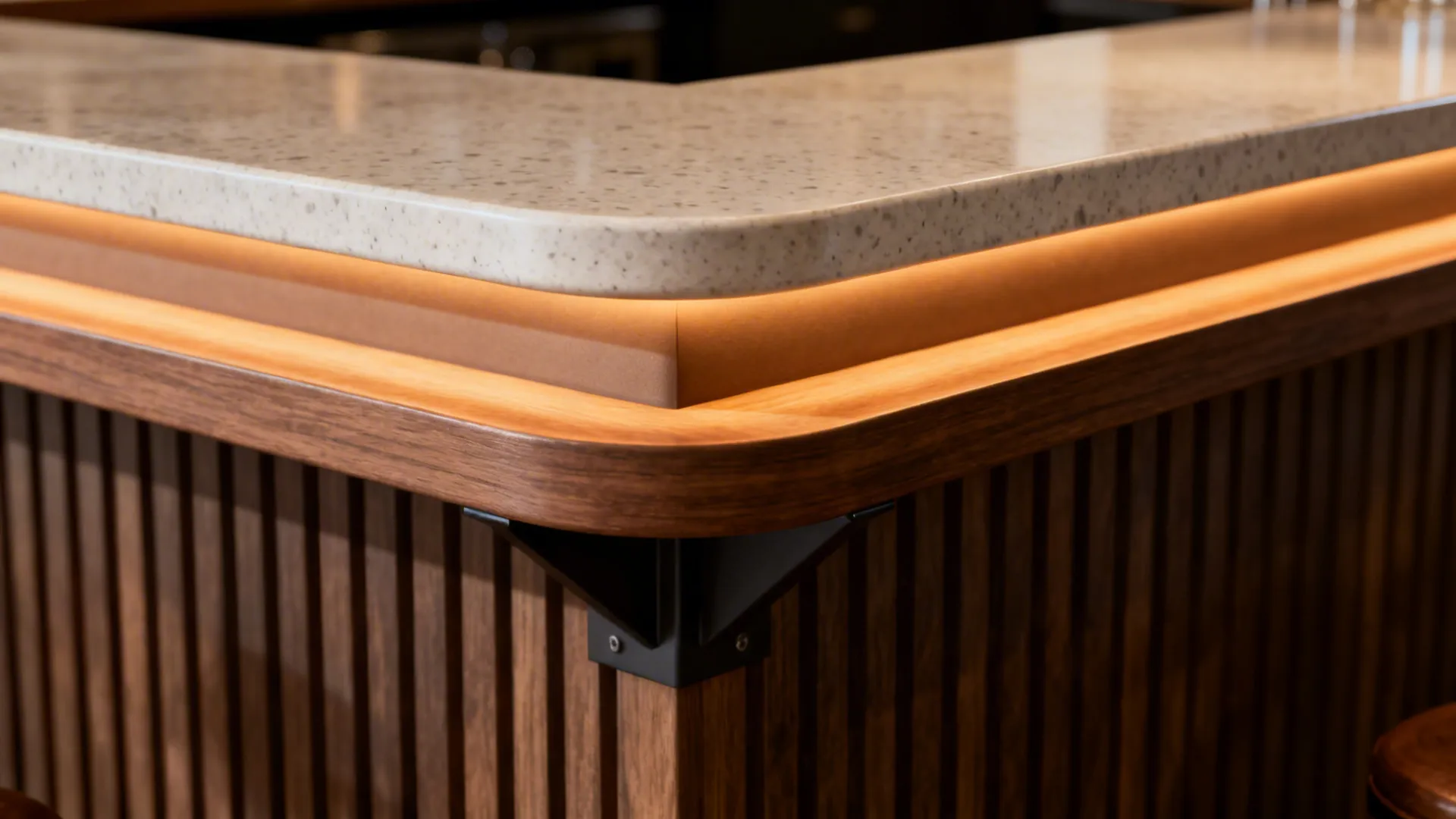 Macro of a raised counter cap with soft radius edge and integrated warm LED channel below.