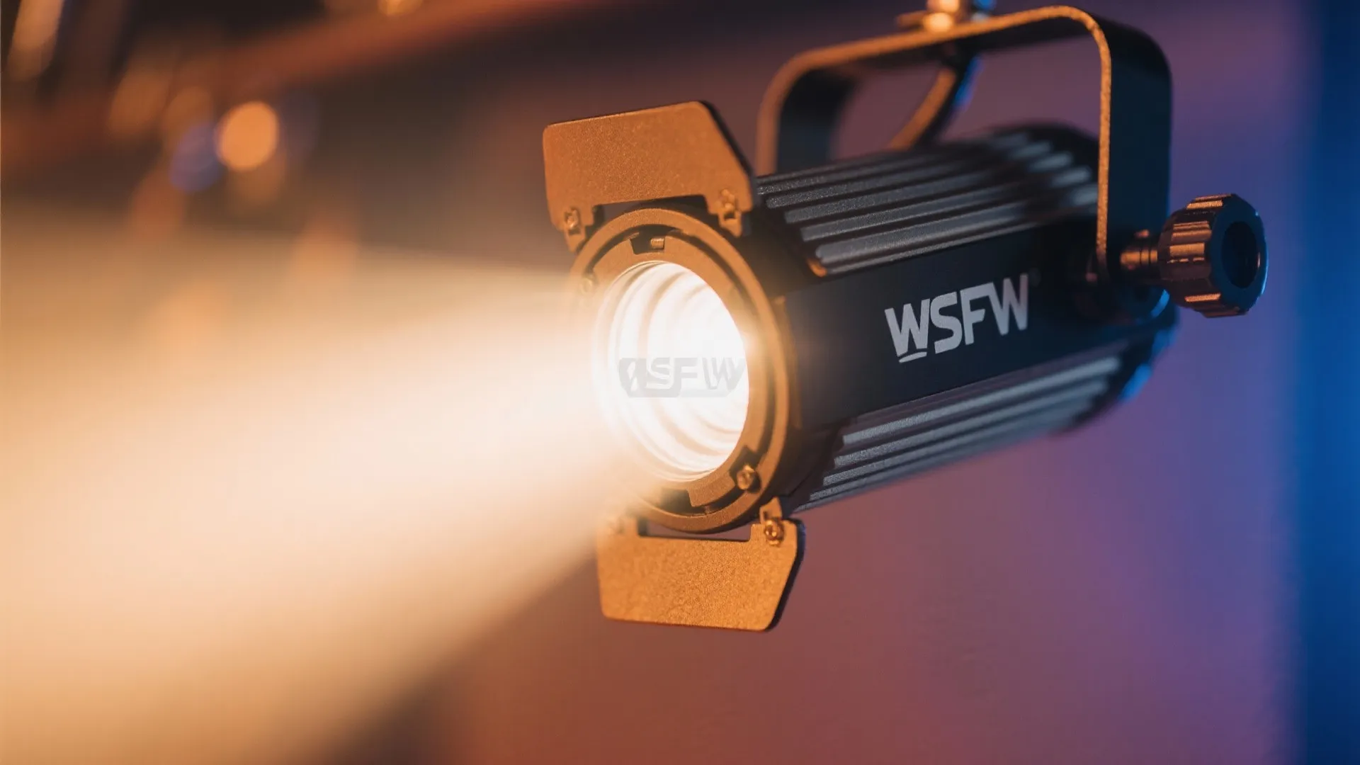 Close up of a professional black light fixture projecting a bright warm beam of light