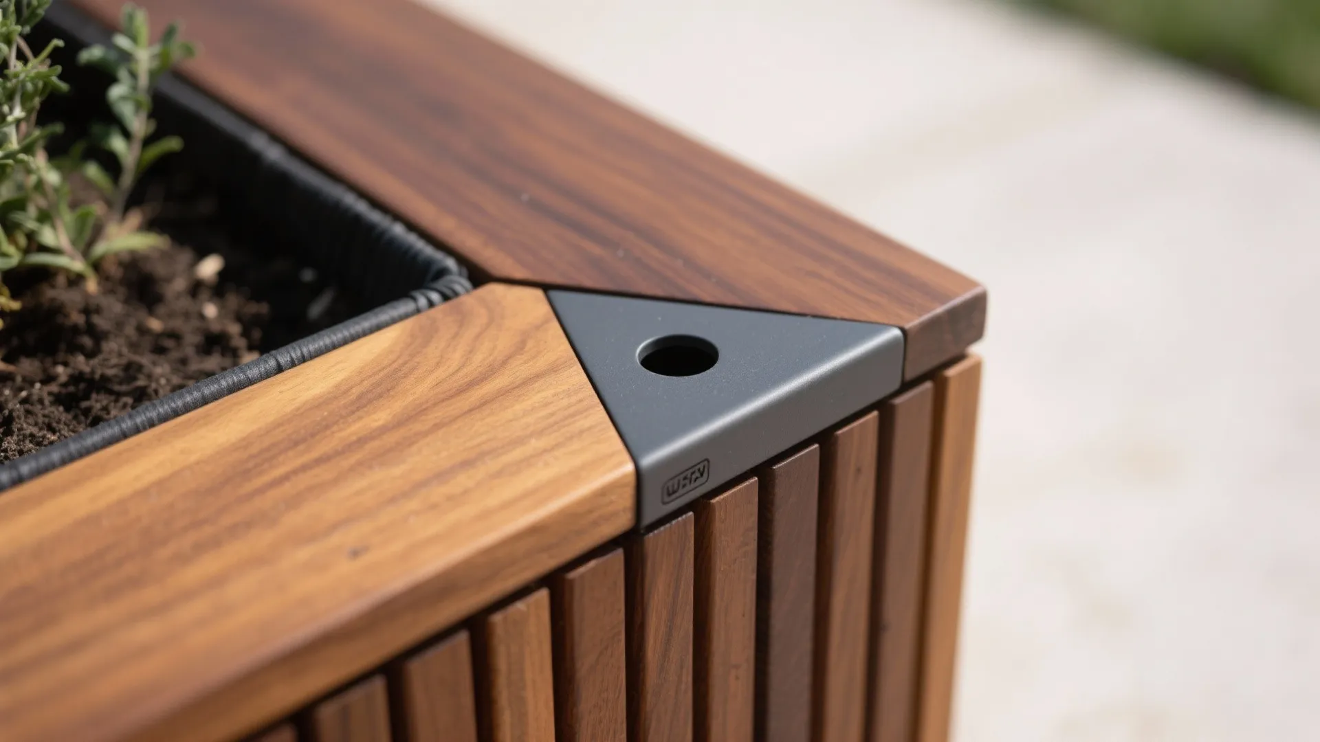 Macro of oiled ipe planter bench corner with beveled edge and EPDM liner detail.