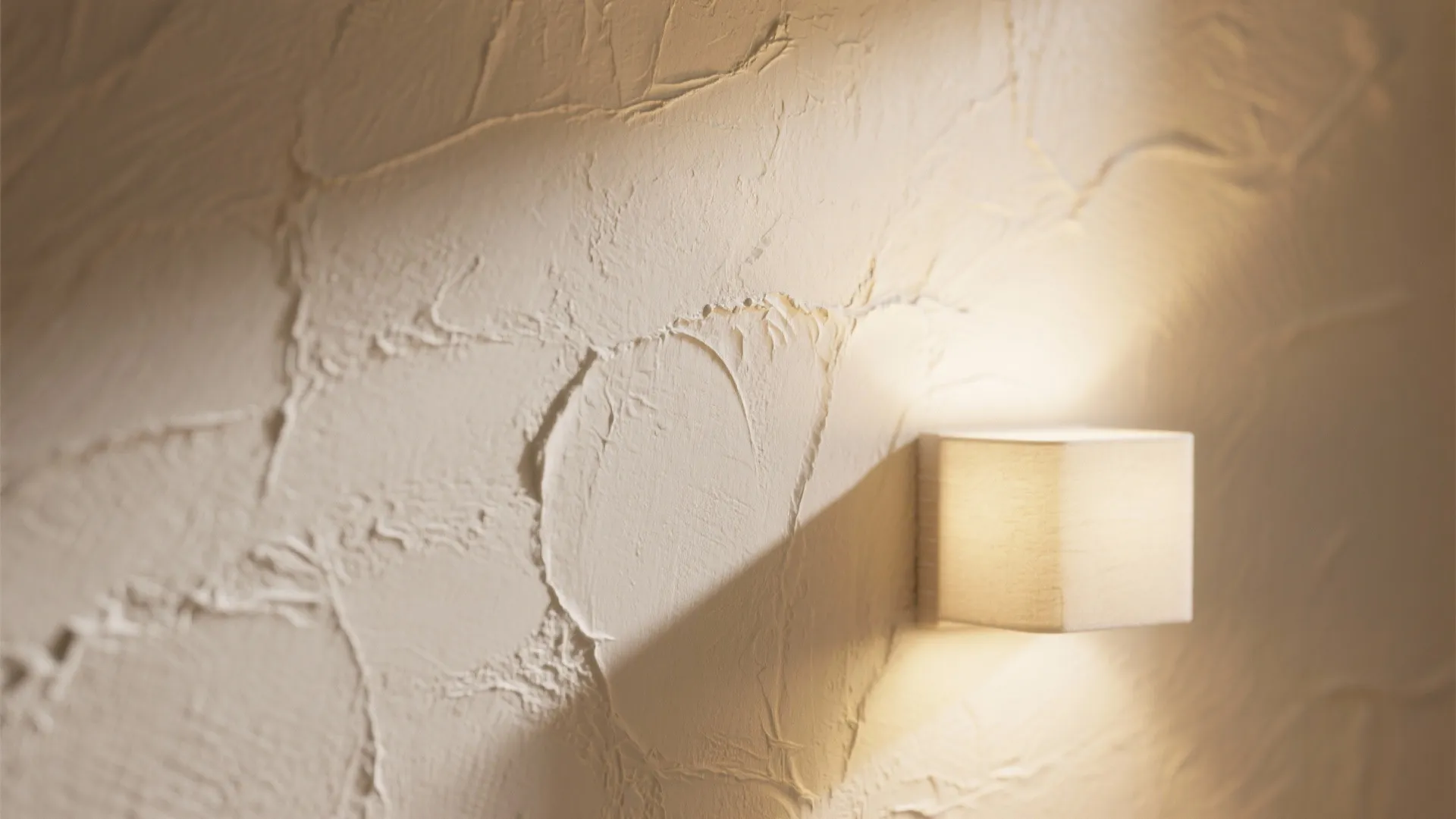 Wall grazing to celebrate texture (brick, fluted panels, plaster)