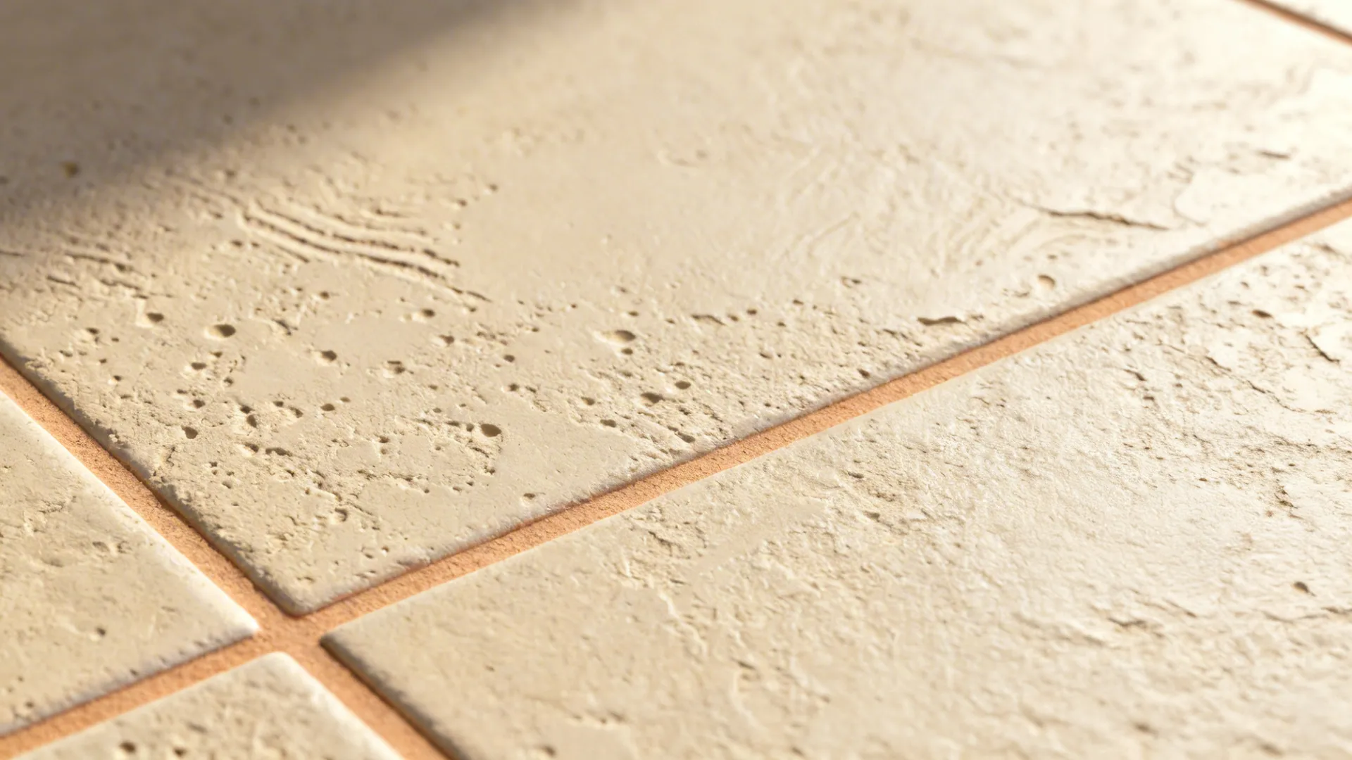 Macro of plaster-look porcelain with subtle relief and tight rectified grout joint.