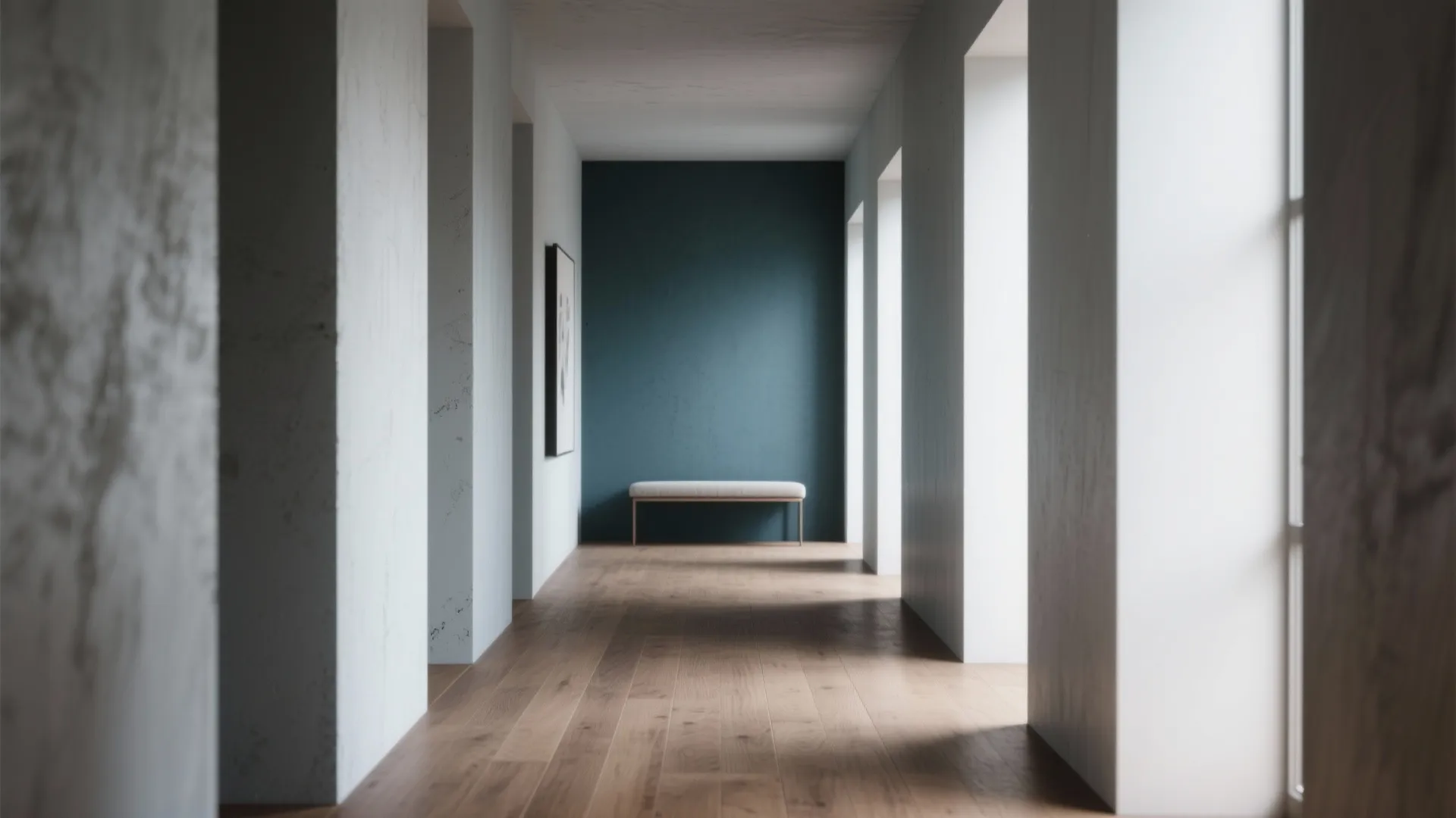 Narrow room with a deep cool-toned accent wall creating perceived depth, minimal furnishings and wood floor.