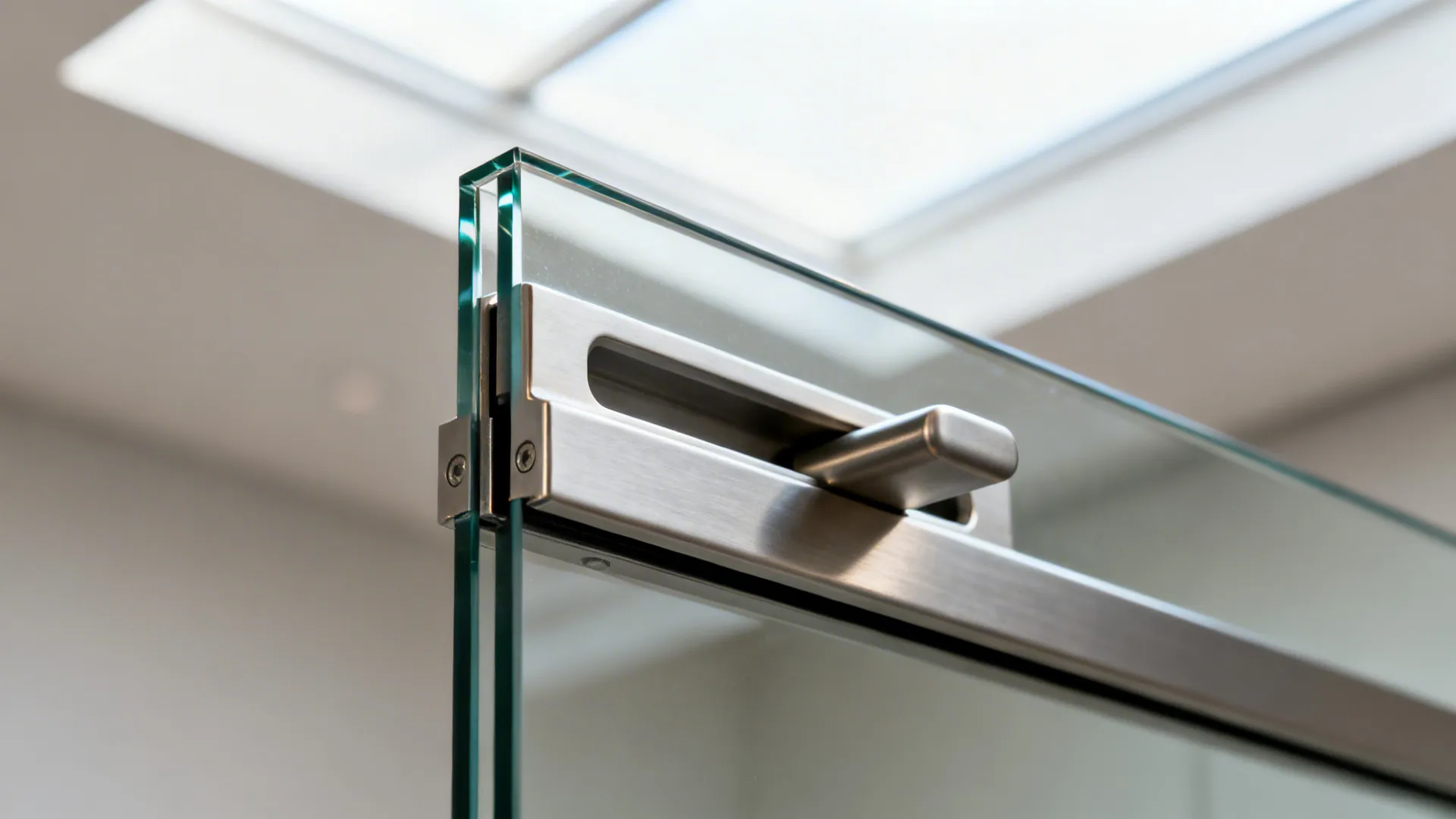 Macro of frameless glass pocket door edge with recessed pull and soft-close track.