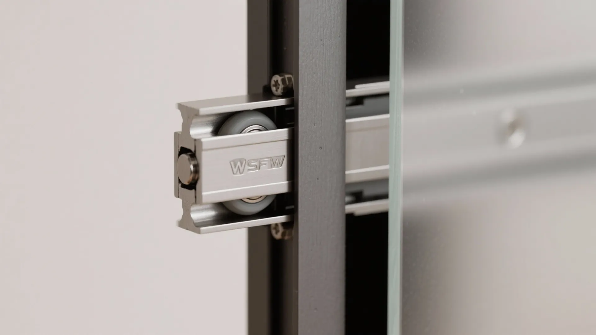 Macro of soft-close sliding pocket door hardware and frosted panel edge.