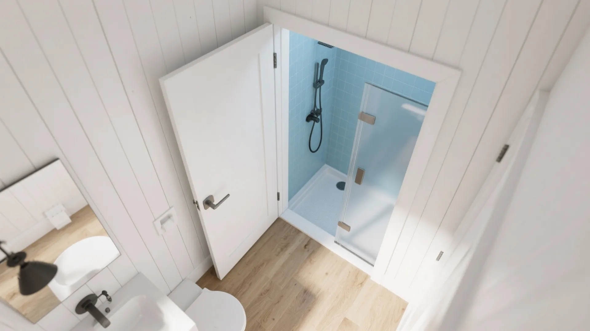 Top-down view of a tiny bathroom showing a pocket door and reclaimed shower space.