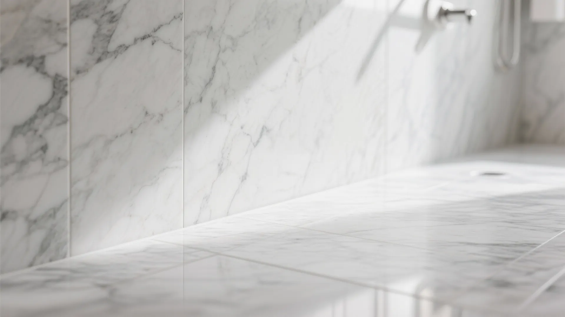 White marble wall and floor tiles with grey veins in a bright and modern bathroom