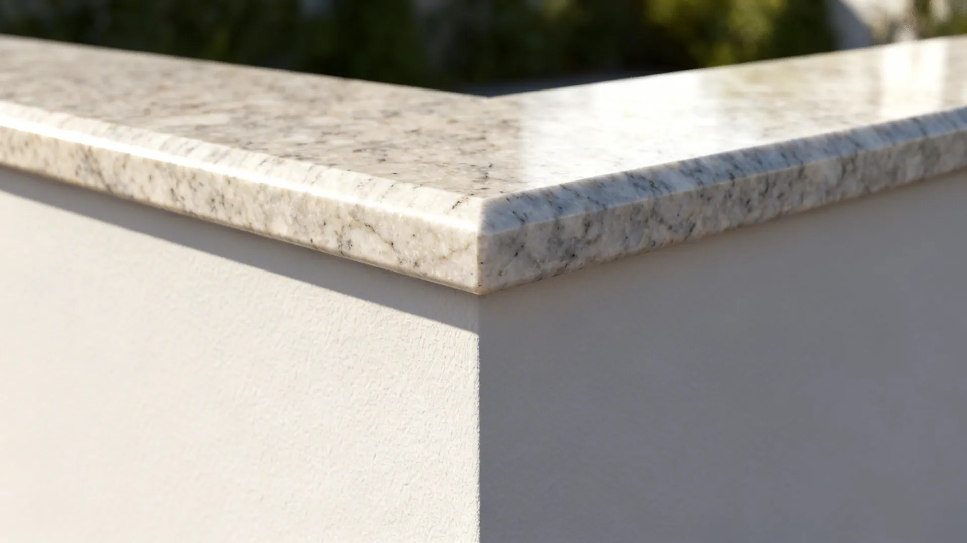 Close-up of a quartz cap on a half wall with eased edge in soft daylight.