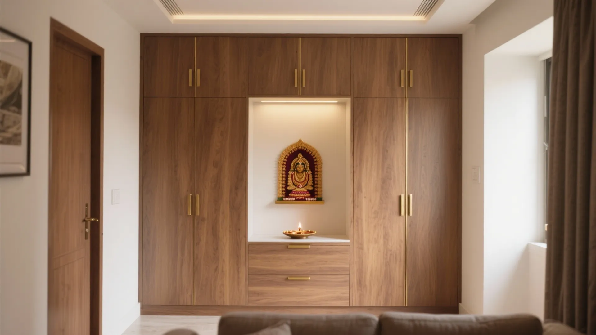 Modern wood wall cabinet with built-in prayer space featuring small statue and warm yellow lighting
