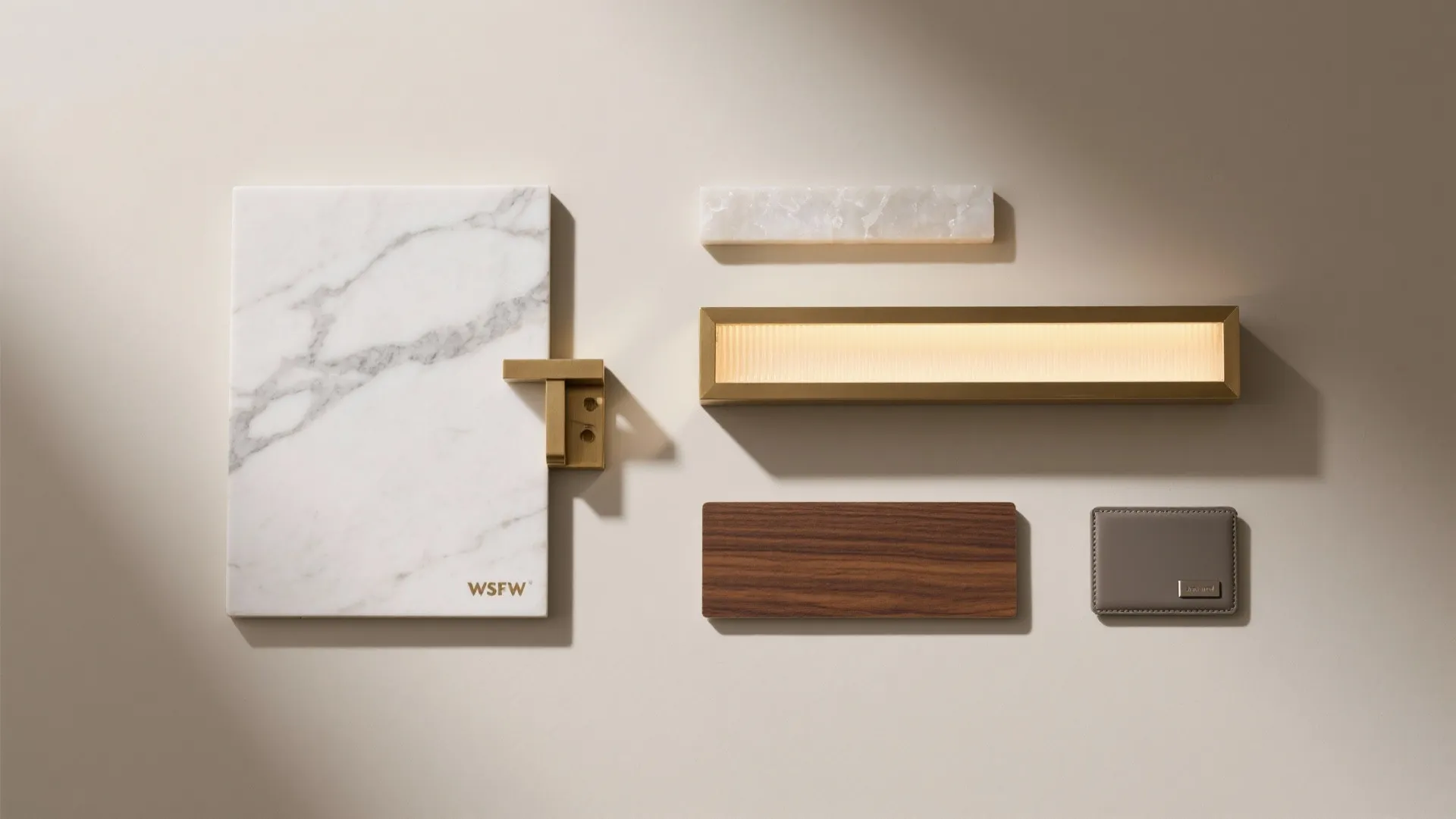 Flat lay of interior design materials including white marble gold light fixture and wood panel