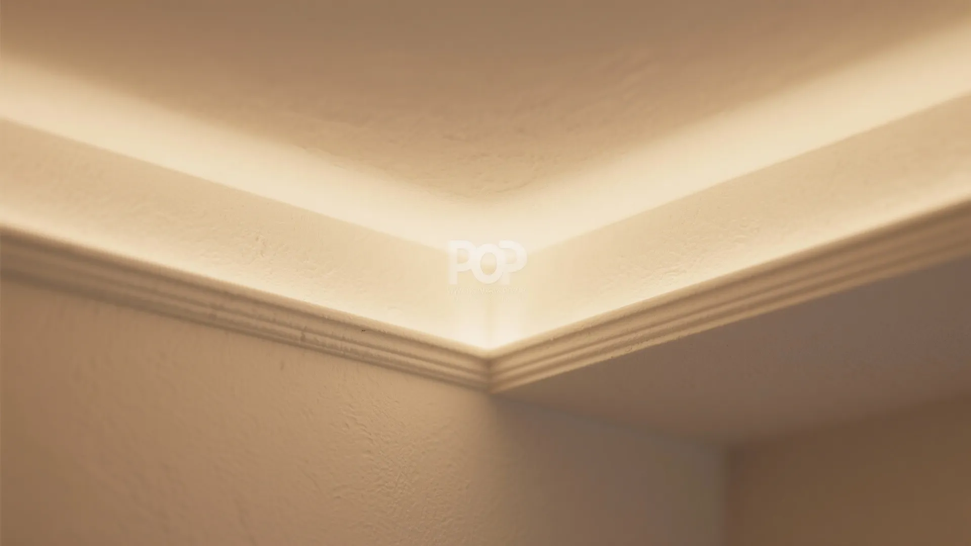 Close up view of warm hidden ceiling lights along the corner of white wall panels
