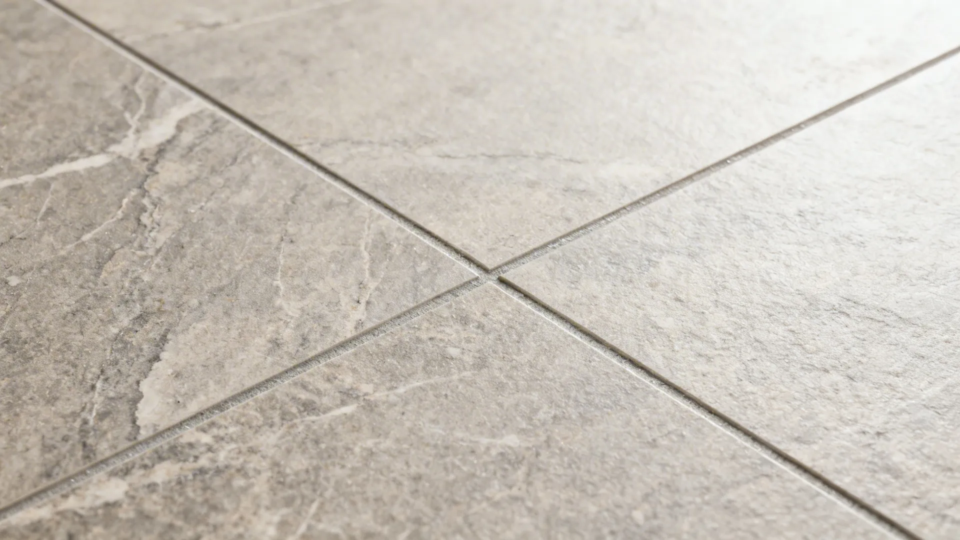 Close up of grey stone floor tiles with clean grout lines in a modern home room